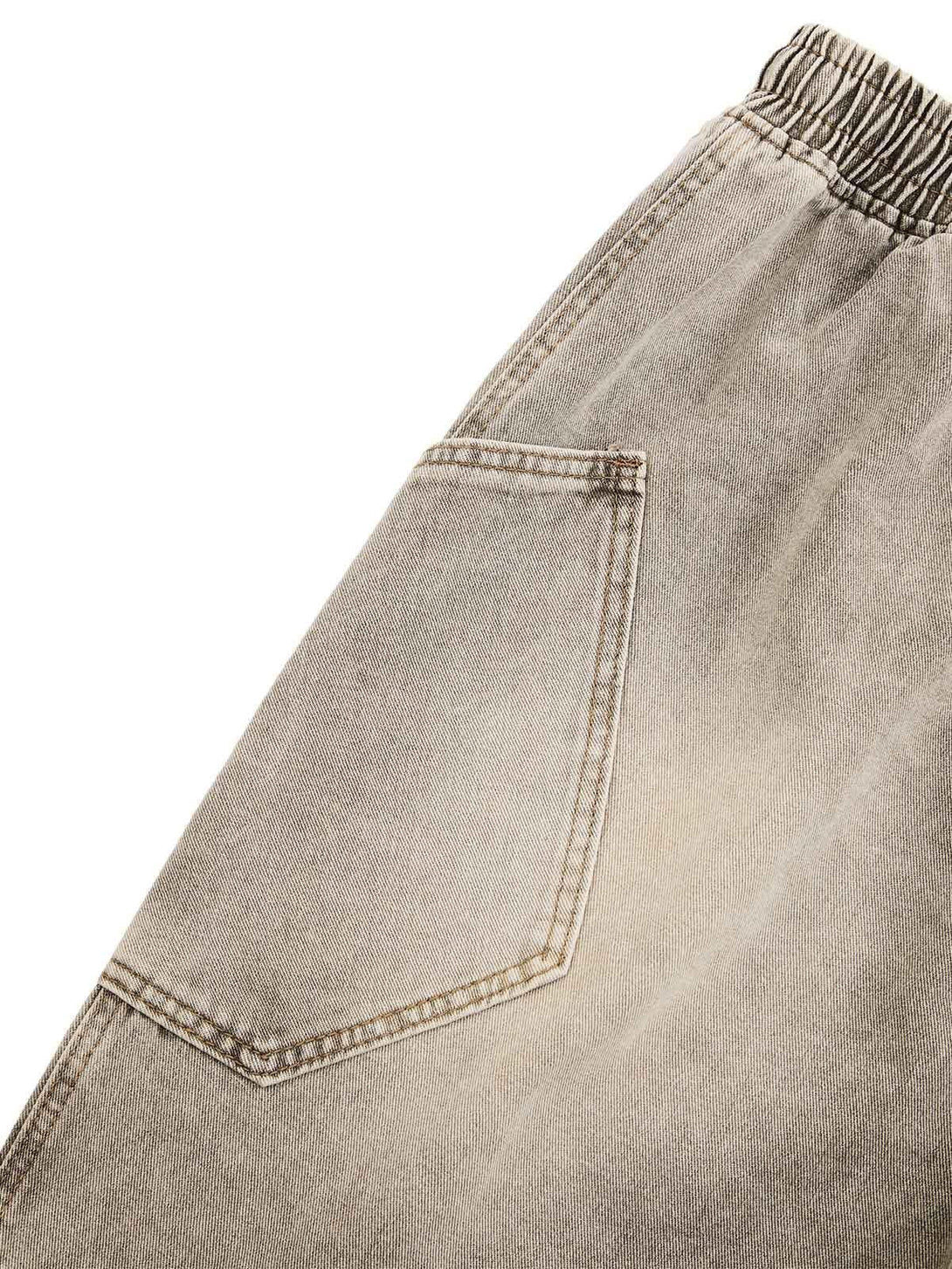 A close-up of TALISHKO denim shorts pocket, highlighting vintage wash and relaxed stitching.
