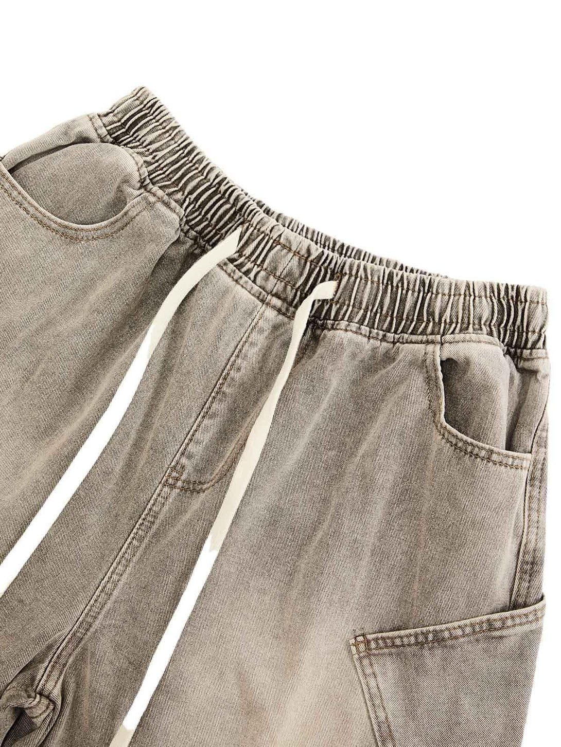 Elastic waist detail of vintage wash denim shorts by TALISHKO, featuring a relaxed fit.