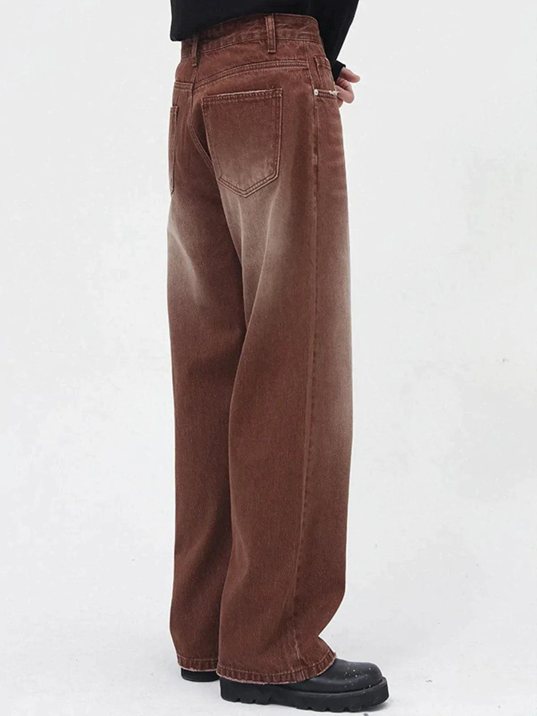 Side view of vintage wash gradient jeans by TALISHKO, highlighting the relaxed wide-leg style.