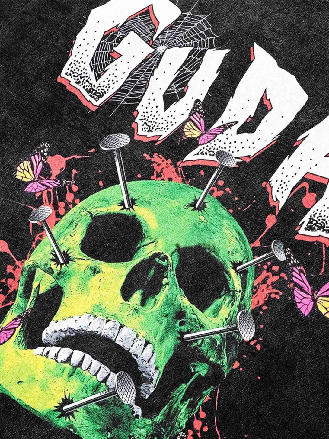 A close-up of a TALISHKO T-shirt featuring a vibrant green skull with nails and butterflies.