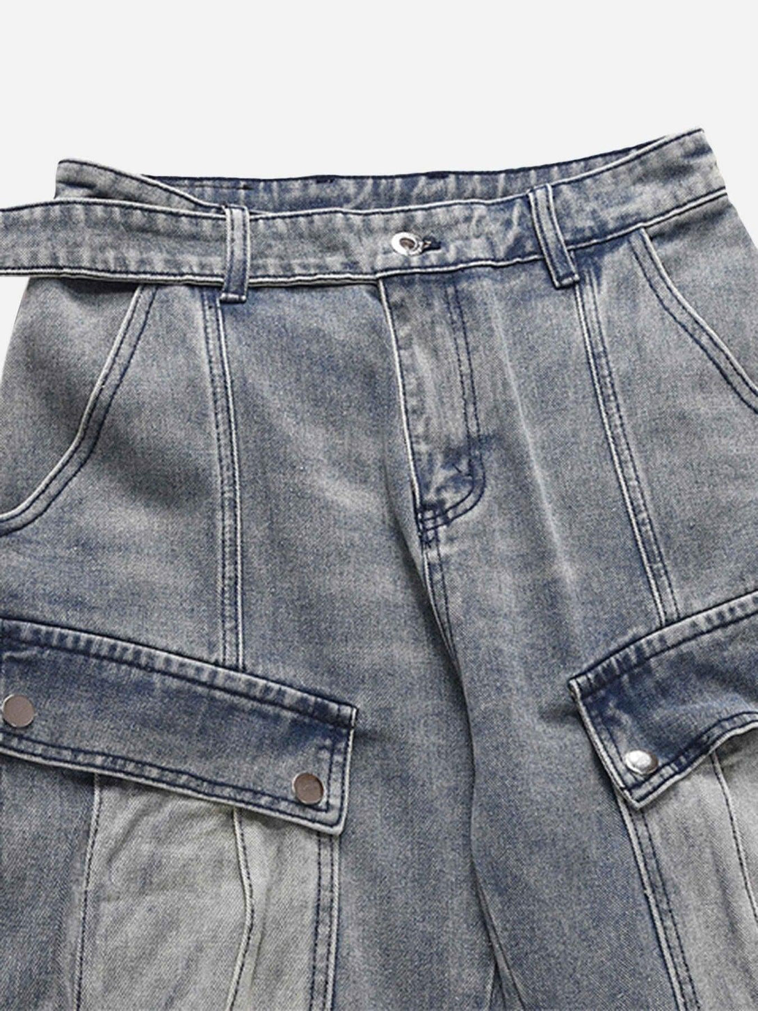 A detailed view of TALISHKO's vintage washed baggy jeans highlighting cargo pockets and stitching.