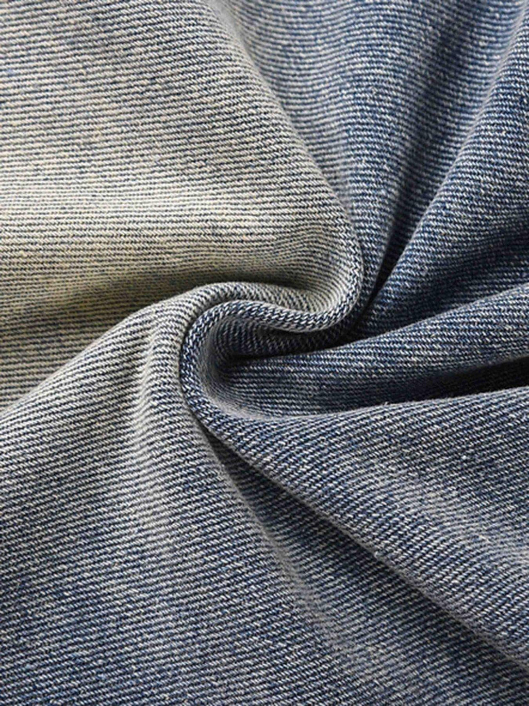 Zoomed-in texture of TALISHKO's vintage washed jeans highlighting intricate fabric weave.