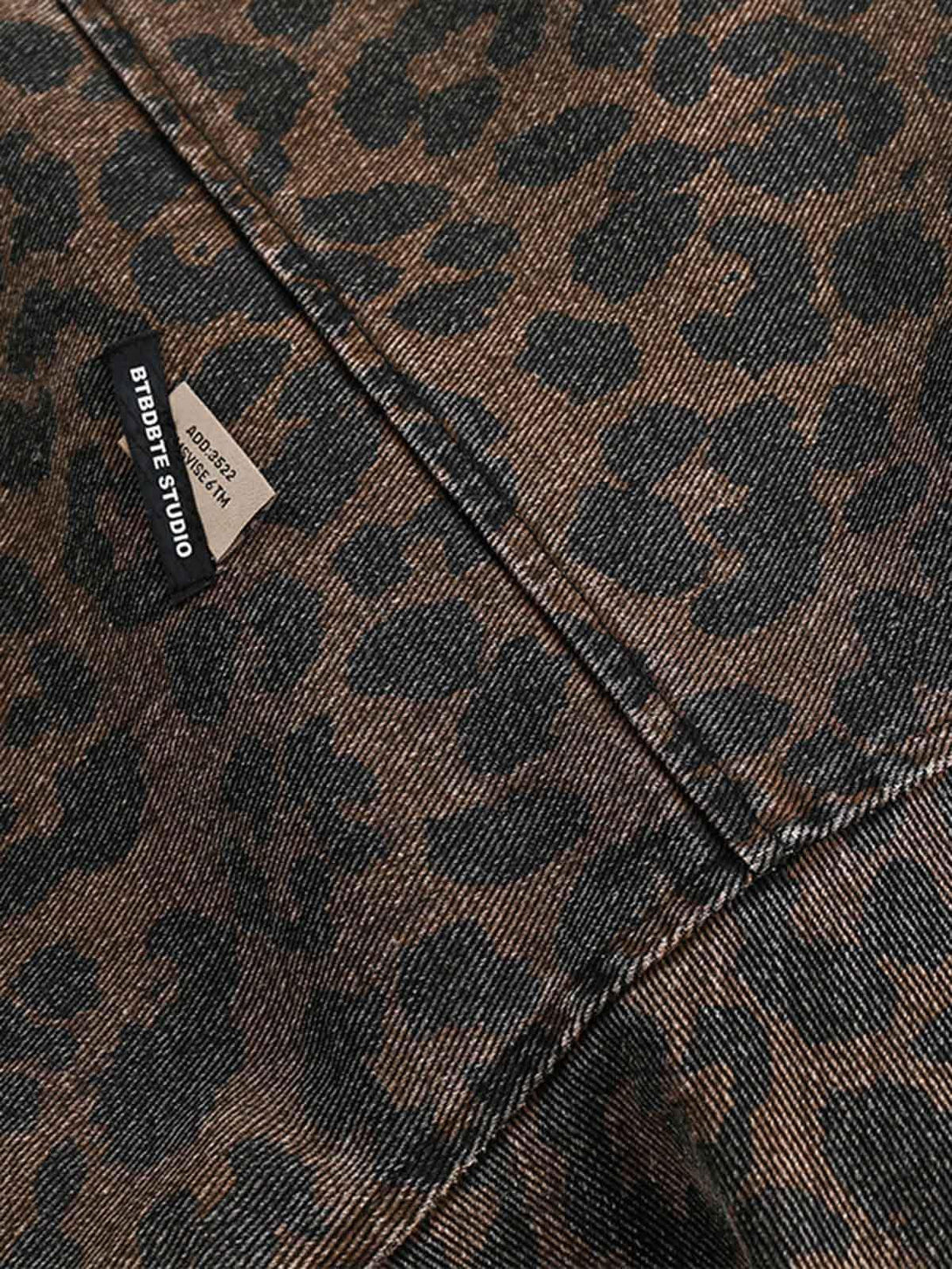 A tight crop highlighting the cheetah pattern on a vintage washed denim jacket by TALISHKO.