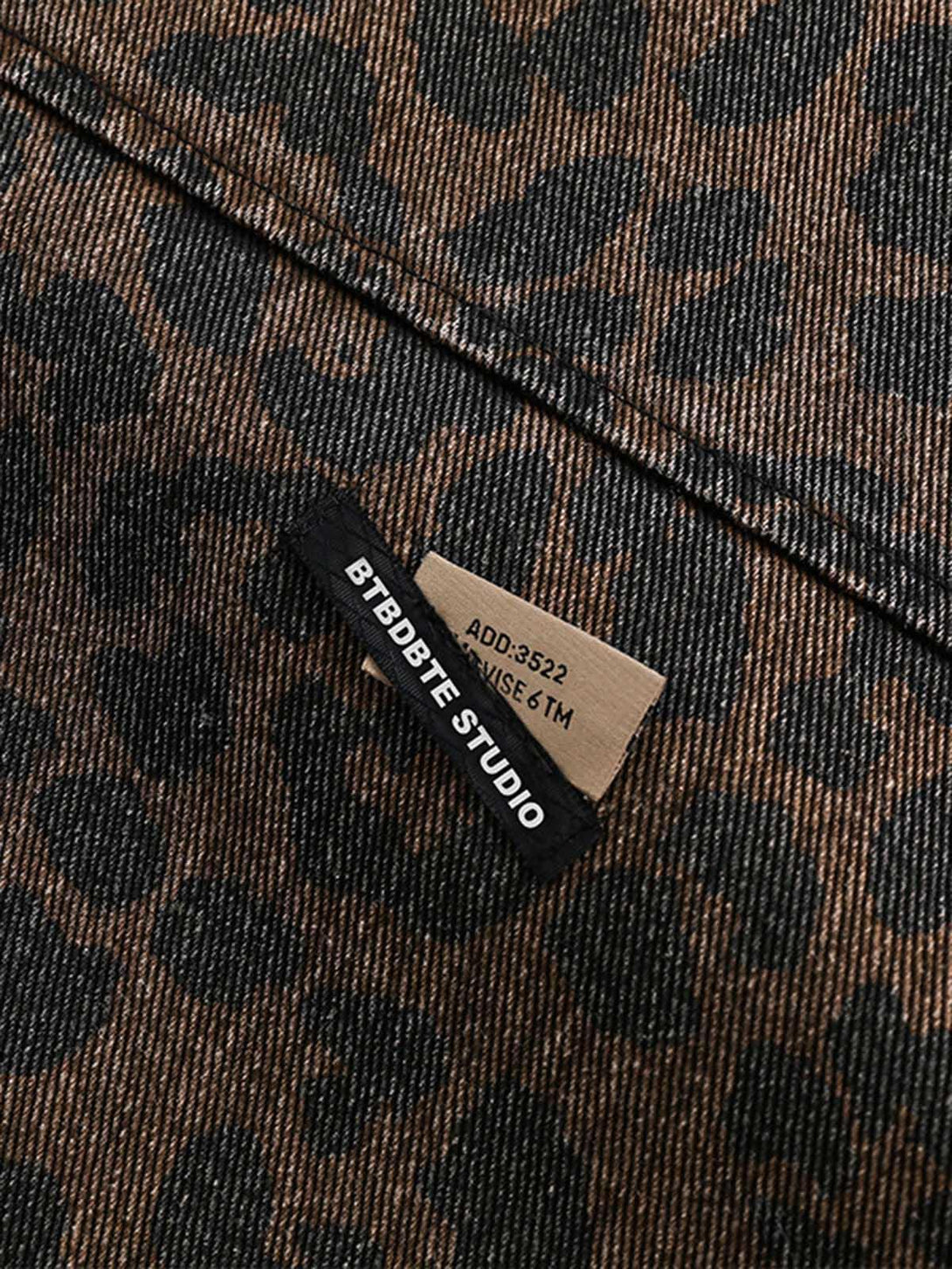 Zoomed-in texture of vintage washed cheetah denim by TALISHKO, highlighting pattern details.