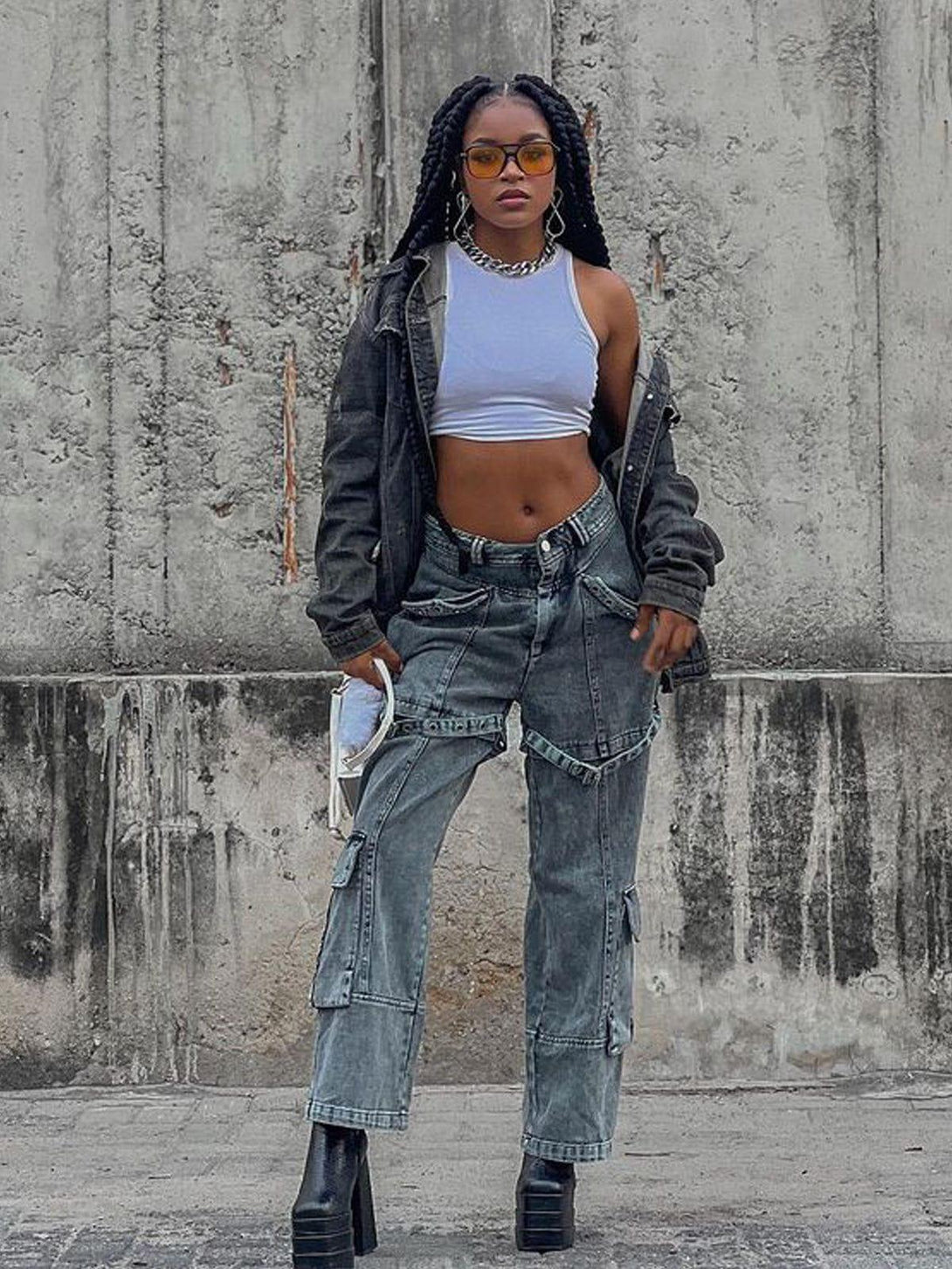 Model wearing TALISHKO vintage washed denim cargo jeans, styled with a cropped top and jacket.