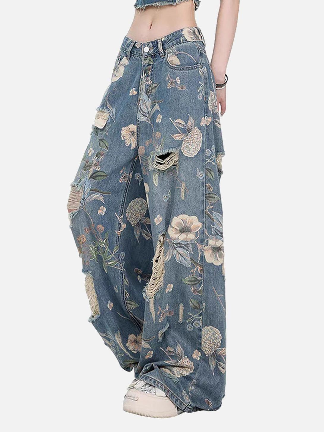 Model in TALISHKO floral ripped baggy jeans, highlighting vintage distressed details.