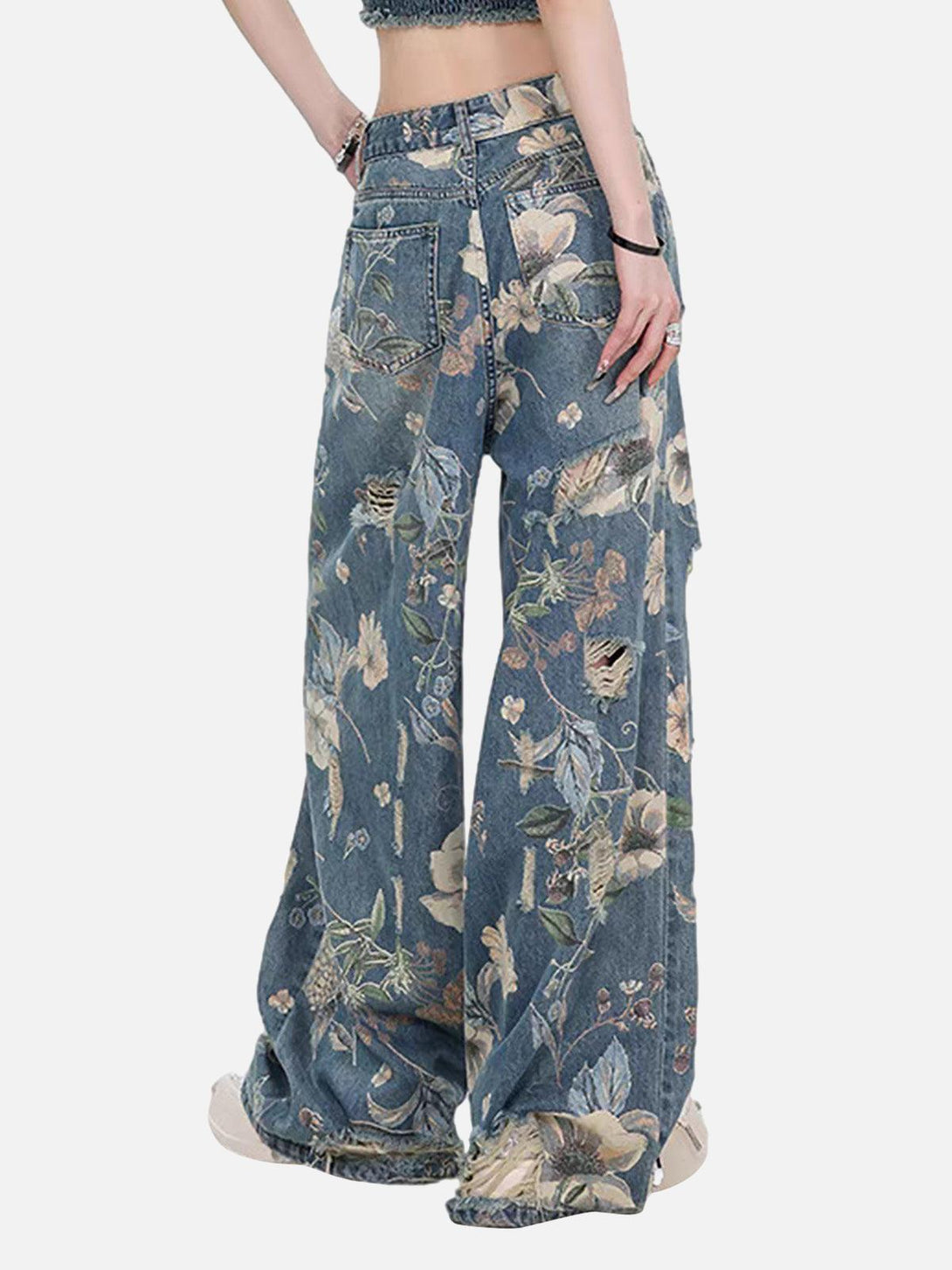 Model wearing TALISHKO's floral ripped baggy jeans, showcasing vintage-inspired details.
