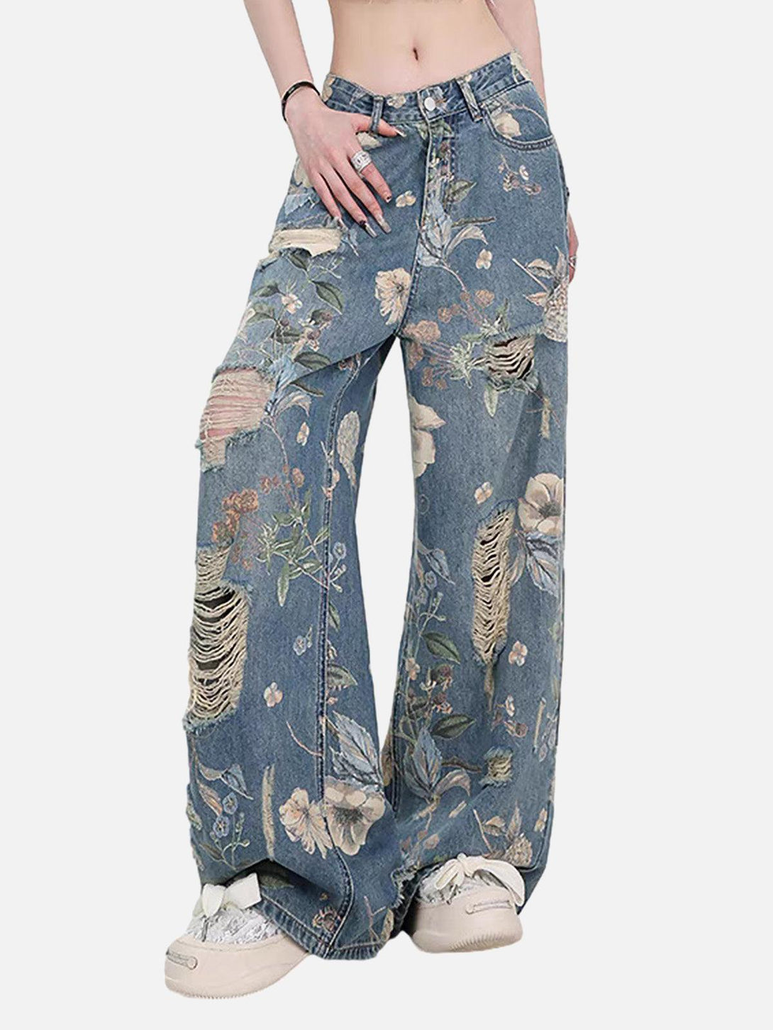 Model showcasing TALISHKO distressed floral baggy jeans with ripped details for a trendy look.