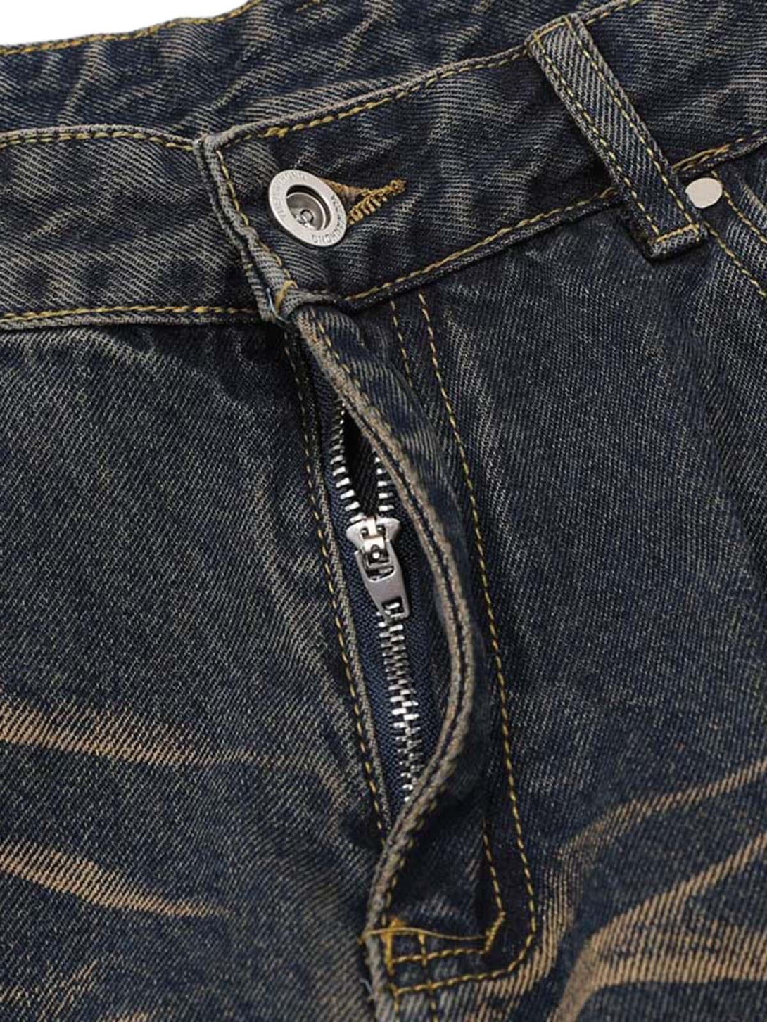 A close-up of TALISHKO vintage washed cargo jeans, highlighting zipper and button details.