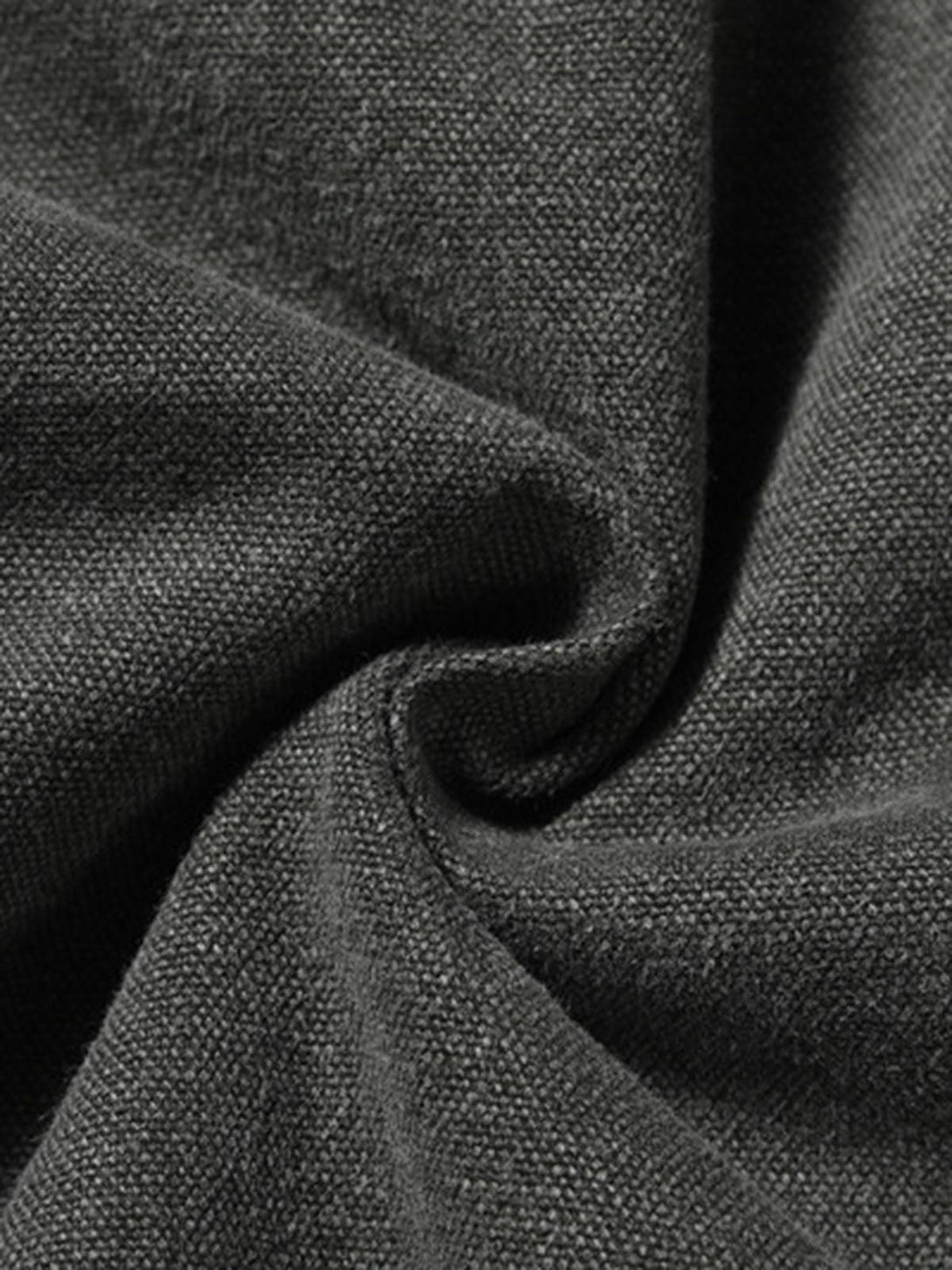 A detailed view of TALISHKO's quilted work jacket fabric, showcasing its vintage texture.