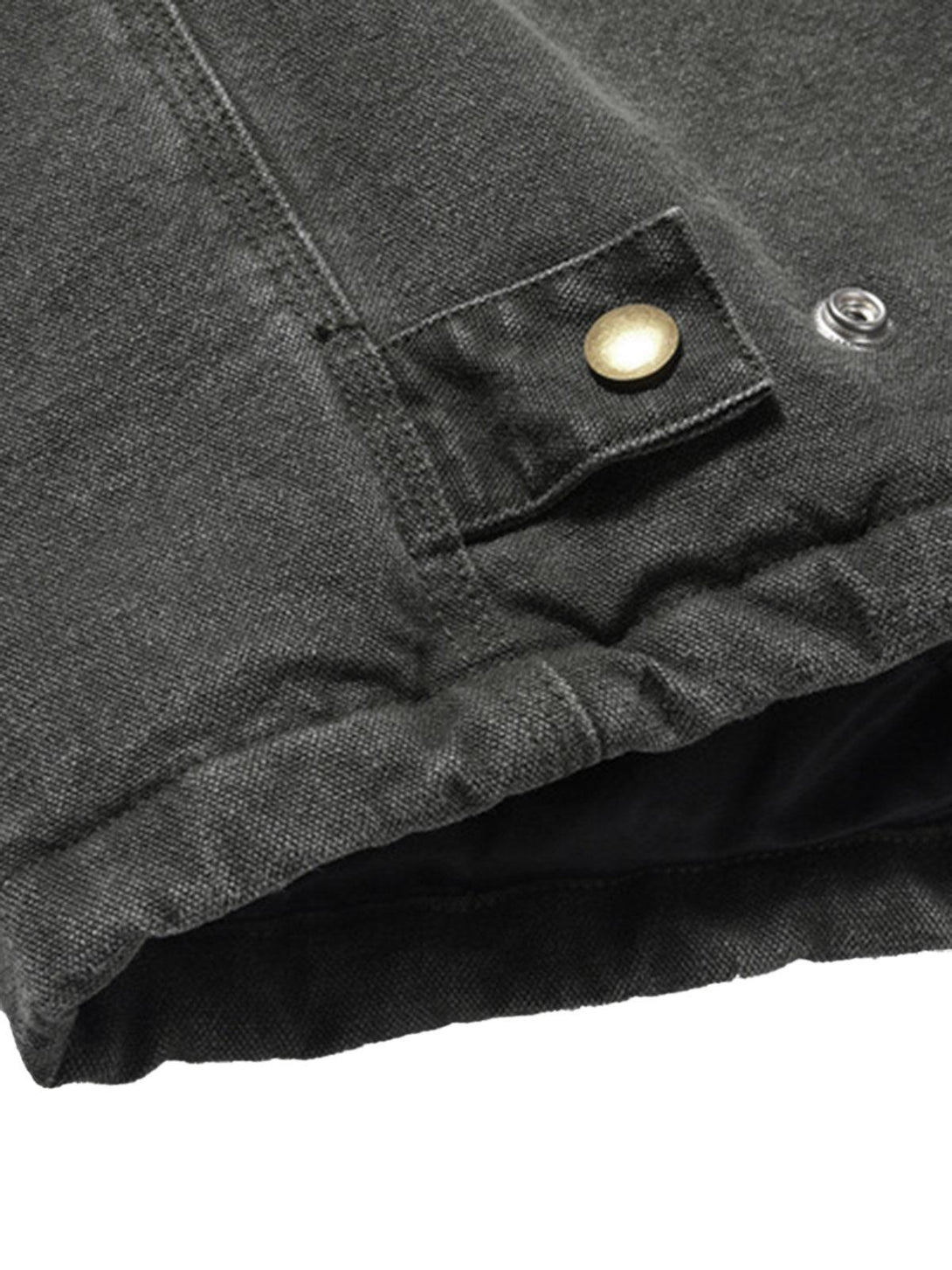 Close-up of TALISHKO's quilted work jacket hem, highlighting vintage stitching details.