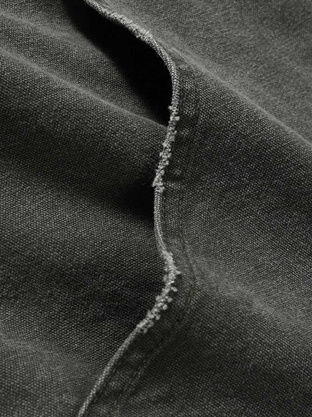 Intricate look at TALISHKO's quilted jacket fabric, emphasizing its distressed texture.
