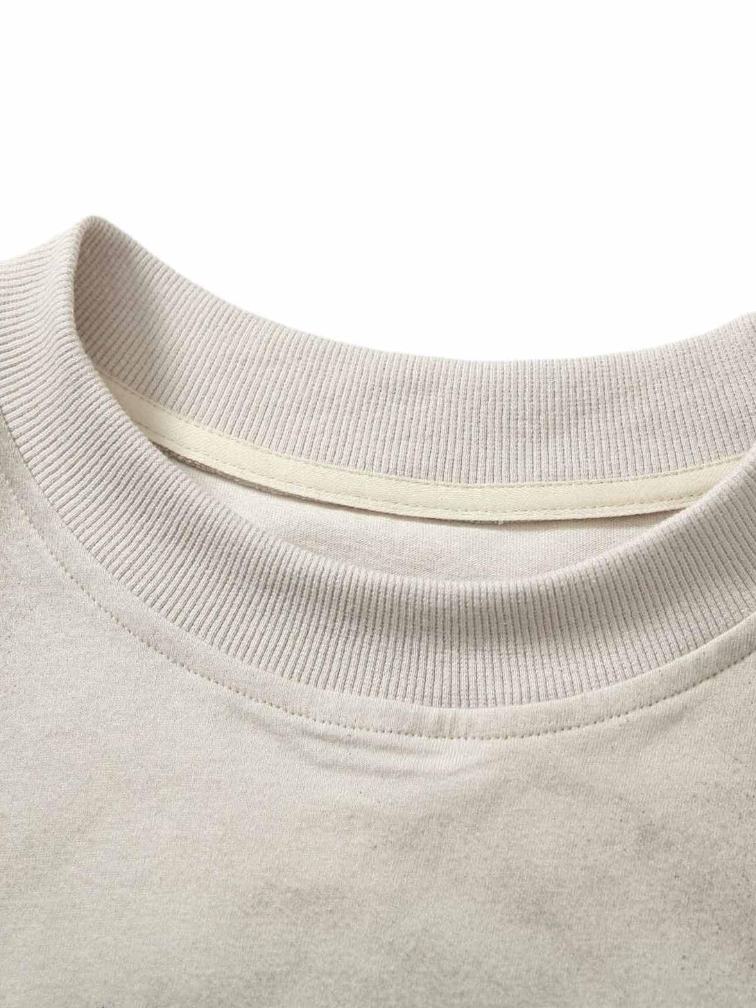 Detailed look at the ribbed neckline of a vintage washed vest by TALISHKO, showcasing texture.