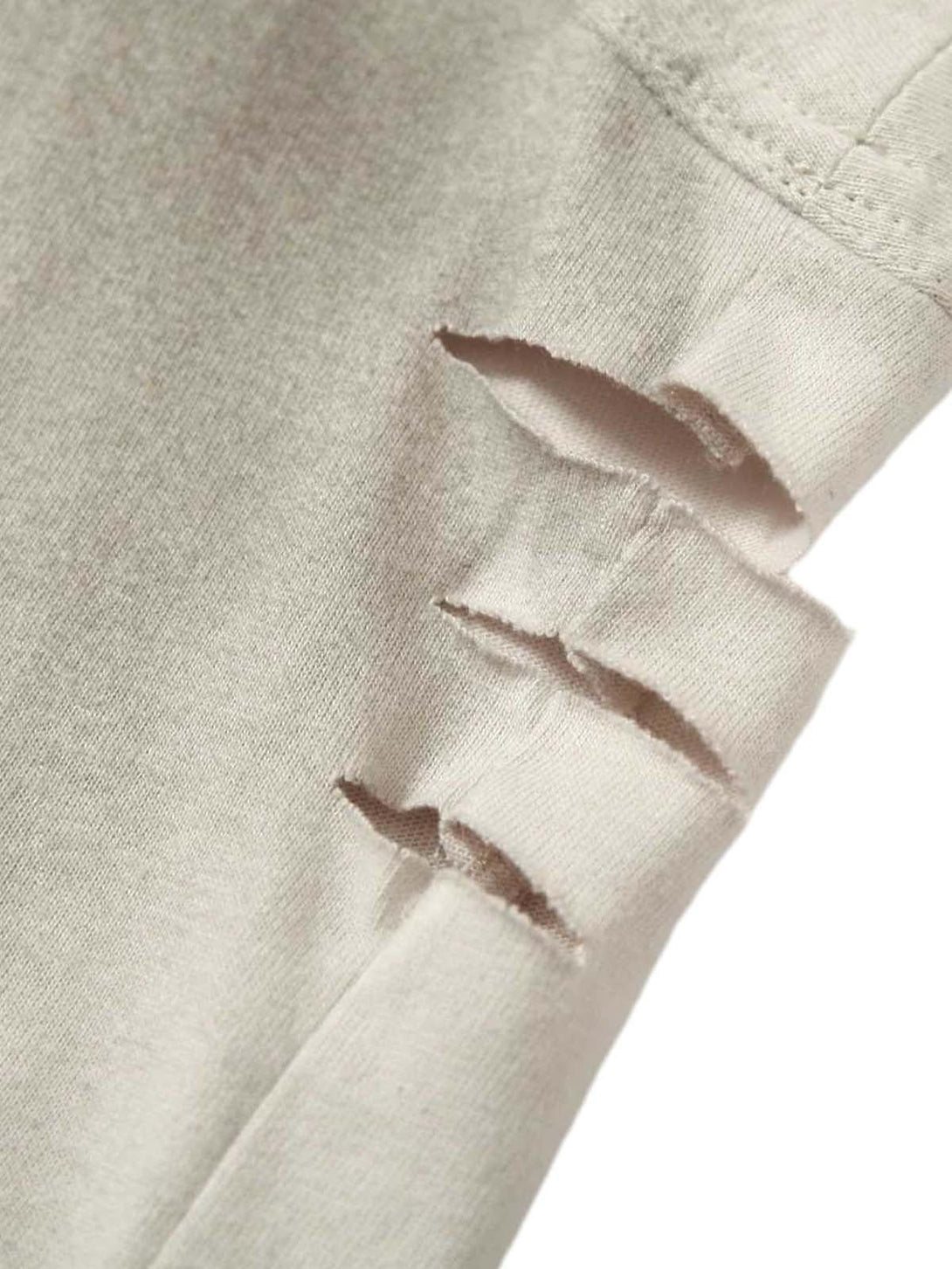 A detailed view of distressed fabric on a vintage washed vest by TALISHKO, highlighting texture.