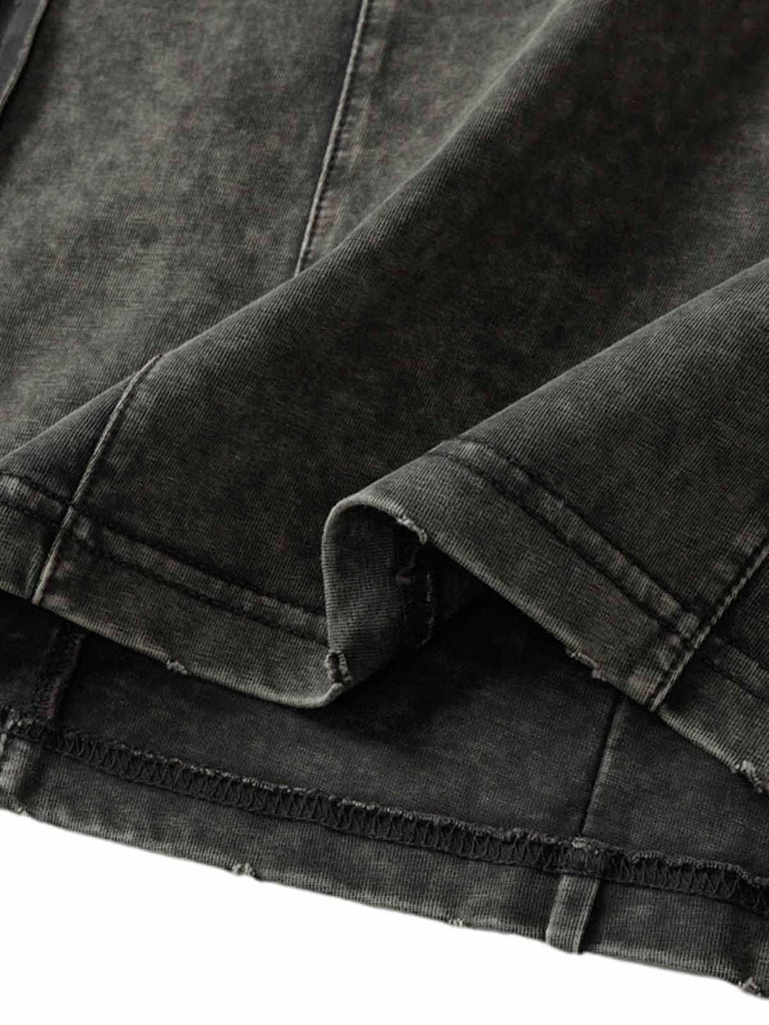 Focusing on the vintage washed fabric of TALISHKO's multi-pocket T-shirt, highlighting texture.