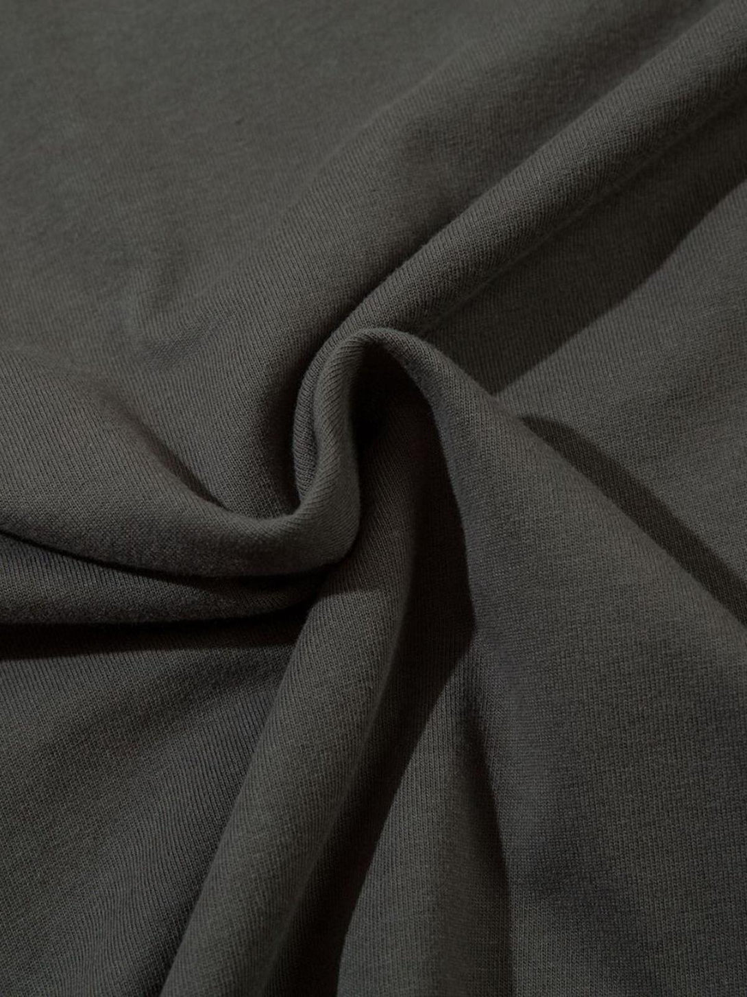 Zoomed-in texture of a vintage-inspired T-shirt fabric by TALISHKO, showcasing intricate stitching.