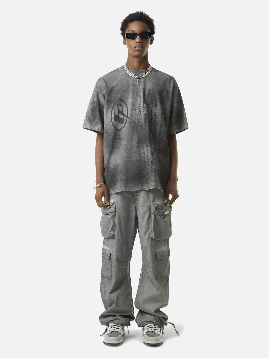 Model in TALISHKO gray vintage work pants and tee, embodying a relaxed streetwear vibe.