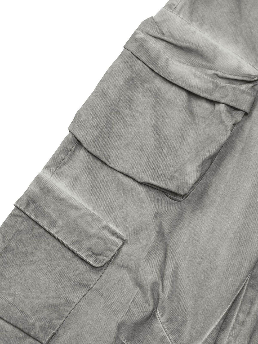 Intricate look at TALISHKO's vintage work pants, focusing on the multi-pocket detail in gray.