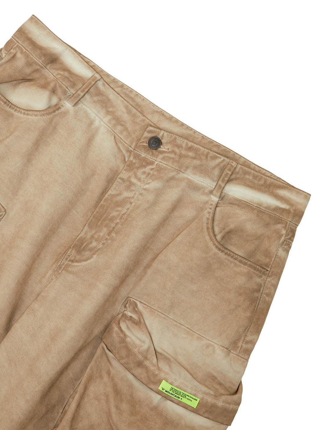 A close-up of TALISHKO's tan vintage work pants, highlighting the multi-pocket design.