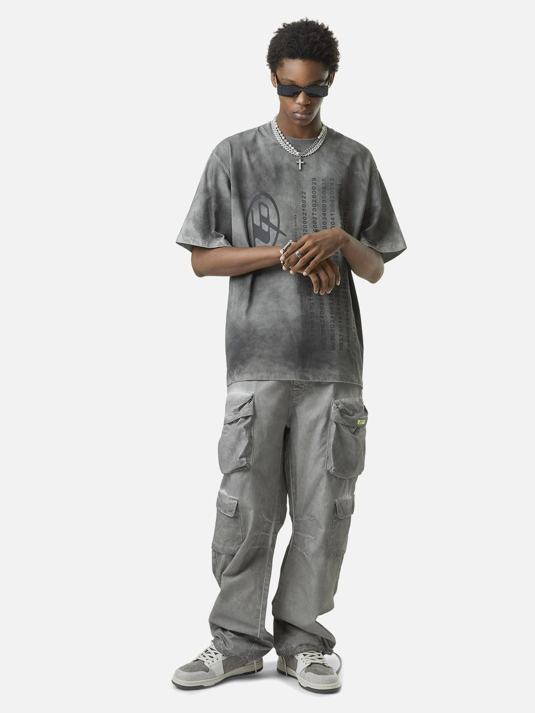 Model in TALISHKO vintage work pants and gray tee, highlighting a casual, urban style.