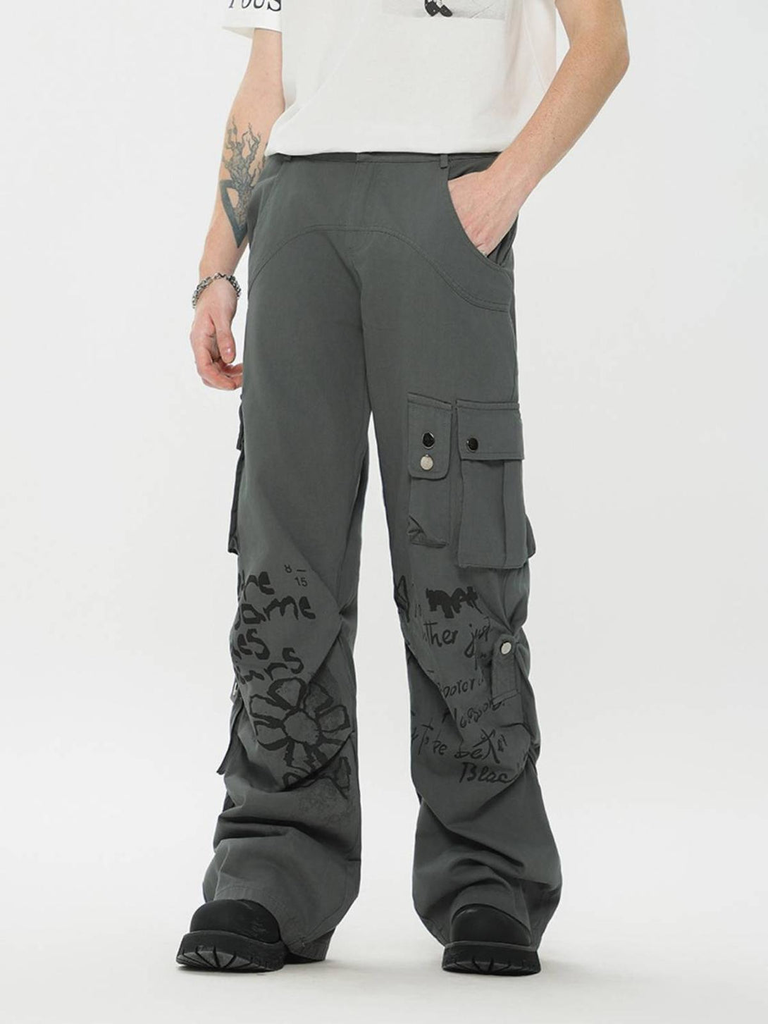 Model wearing TALISHKO vintage cargo pants with graphic prints, showcasing a relaxed urban vibe.