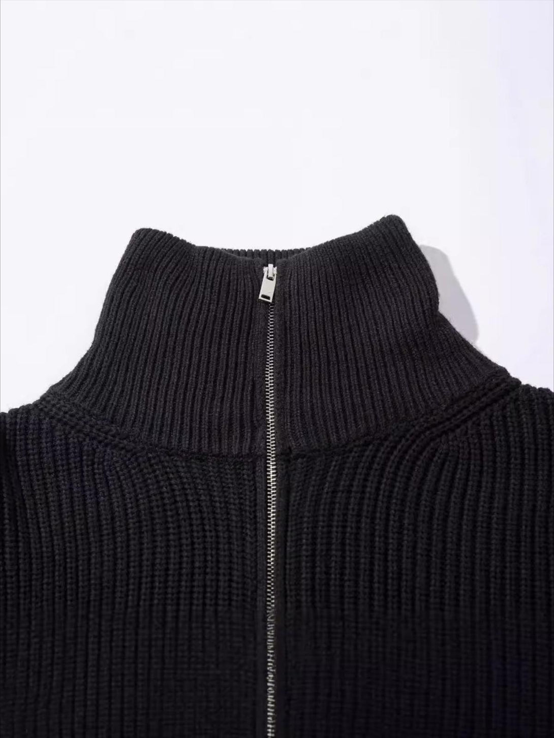 Texture and pattern showcased in this black ribbed zipper sweater, designed by TALISHKO.