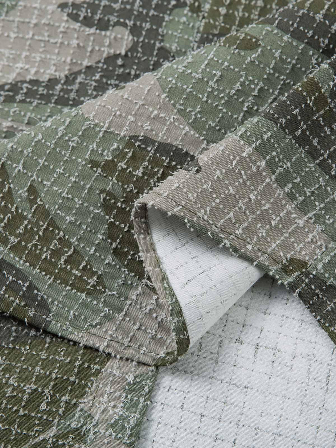 Texture and pattern showcased on the camouflage fabric by TALISHKO, featuring intricate details.
