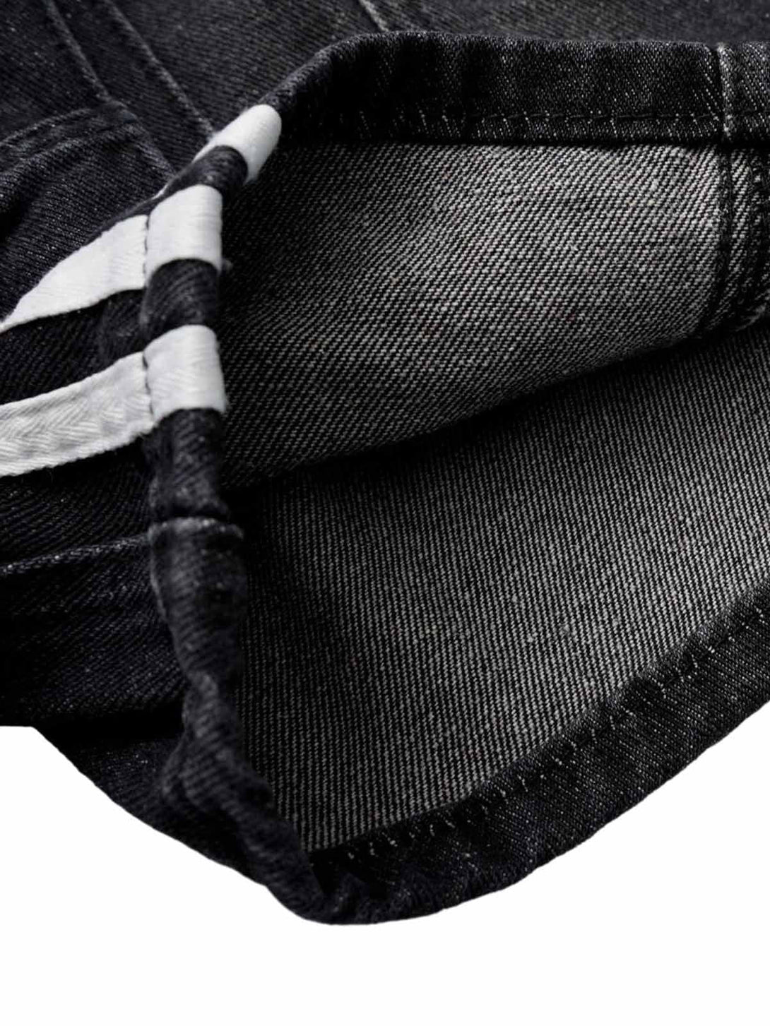 "Detailed fabric and stitching on TALISHKO's washed cargo denim shorts, showcasing craftsmanship."