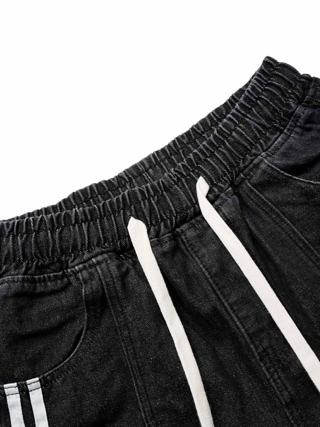Detailed view of TALISHKO black washed cargo denim shorts with drawstring and elastic waistband.
