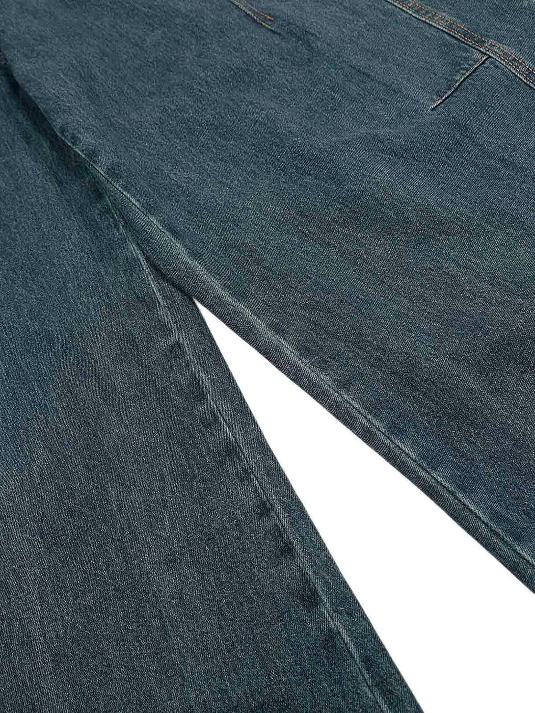 Zoomed-in texture of TALISHKO's washed baggy jeans, showcasing the deconstructed fabric.