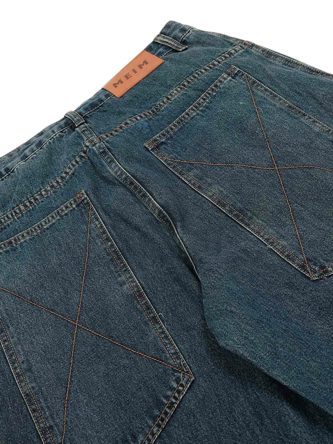 Back detail of TALISHKO's washed baggy jeans, highlighting unique pocket stitching.