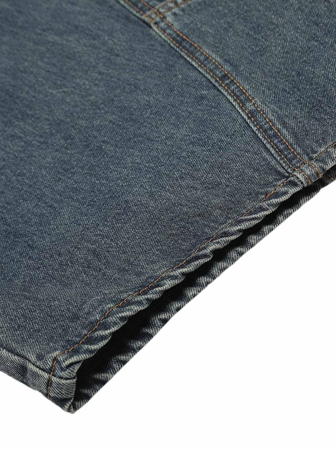 Detailed fabric view of TALISHKO's washed baggy jeans, highlighting intricate stitching design.