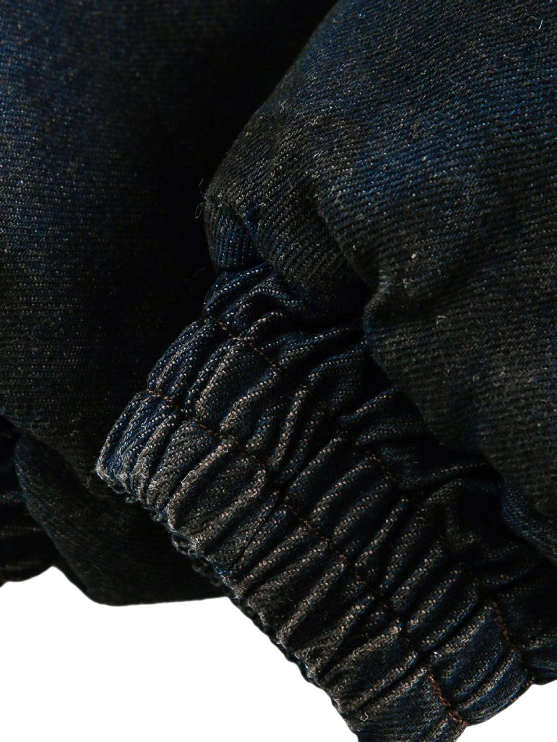 Elastic cuff detail of TALISHKO's washed denim jacket, showcasing durable stitching.