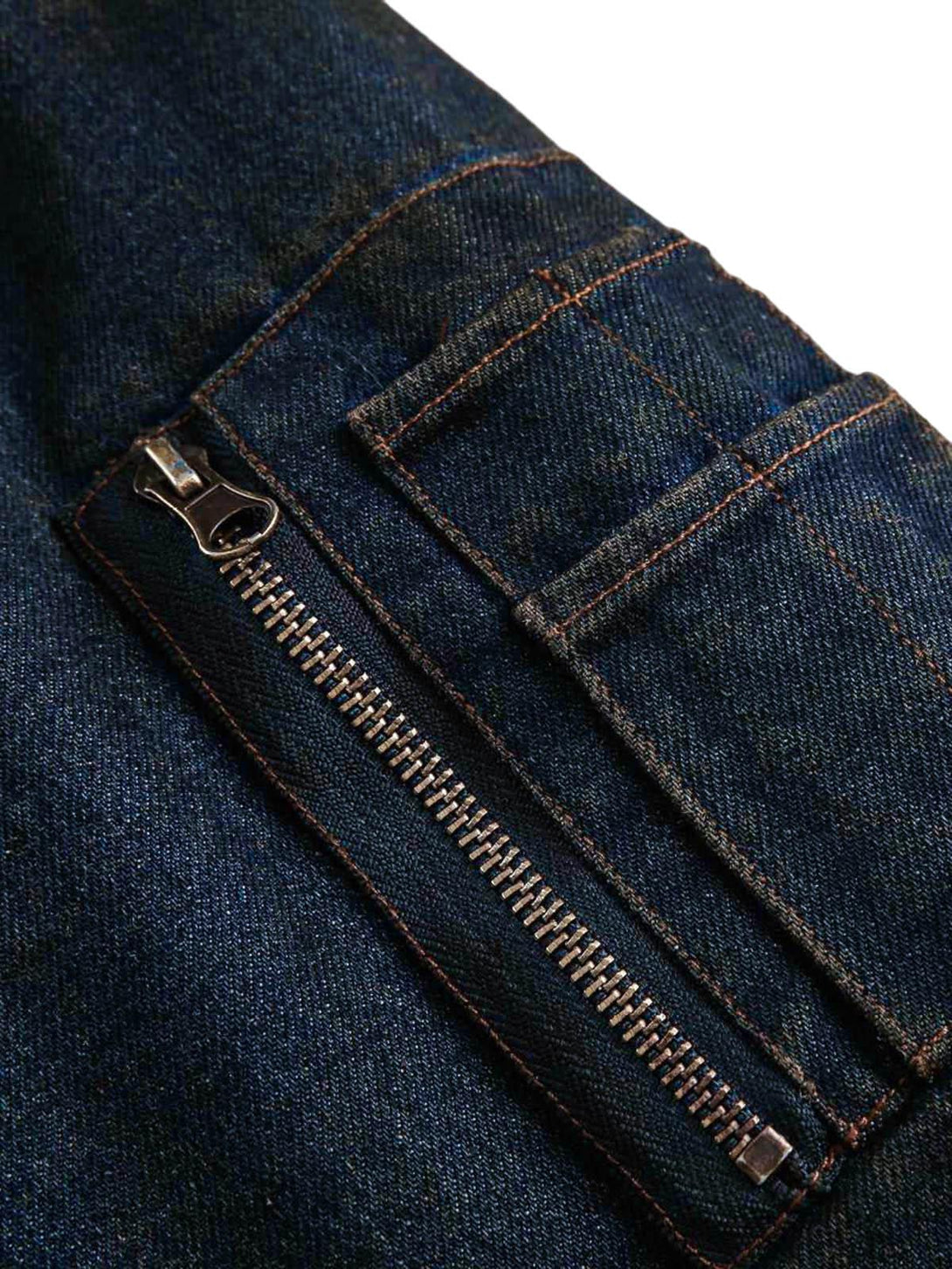 Detailed view of a TALISHKO denim jacket zipper, highlighting its sturdy design and texture.