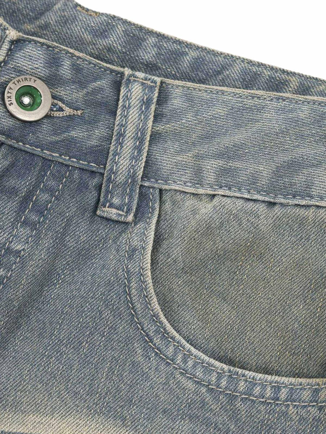 A close-up of TALISHKO hip-hop shorts, showcasing the washed denim texture and stitching.