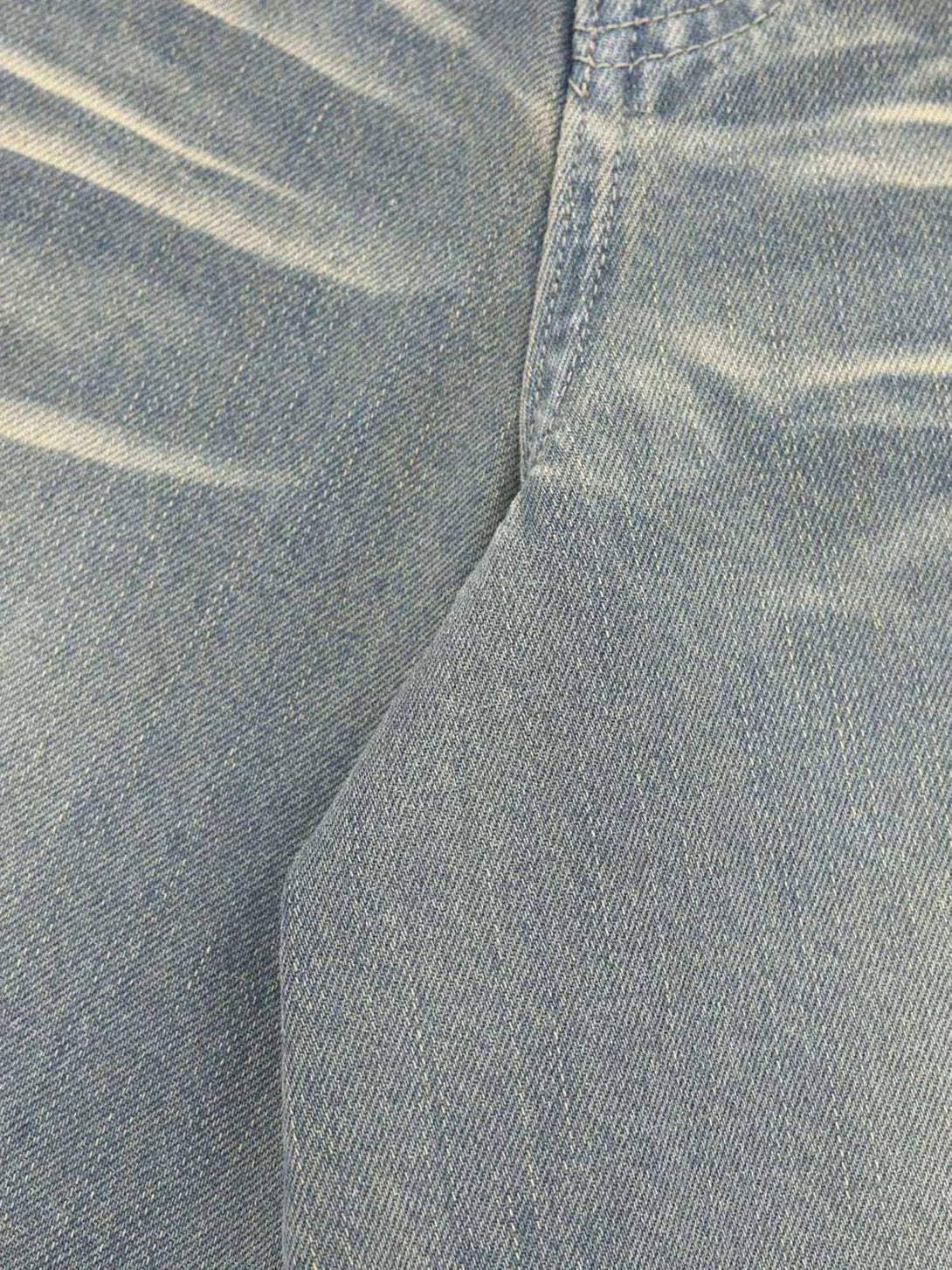 Intricate look at the washed denim texture of TALISHKO hip-hop shorts with stylish fading.