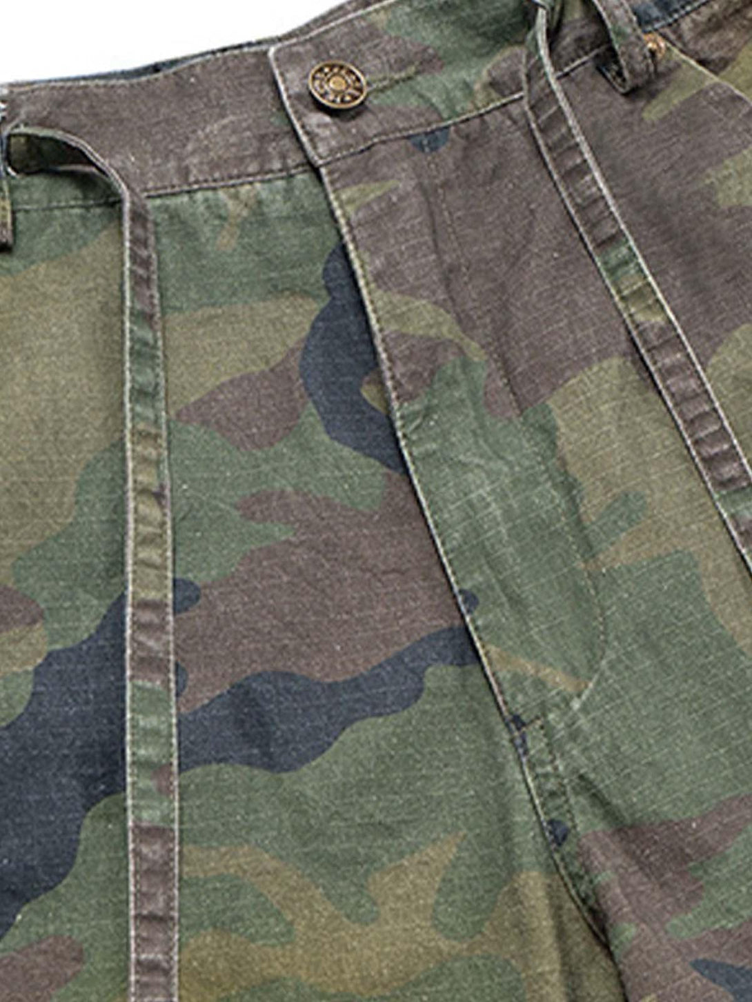 Intricate look at TALISHKO's washed camouflage cargo shorts, featuring drawstring and rugged texture.