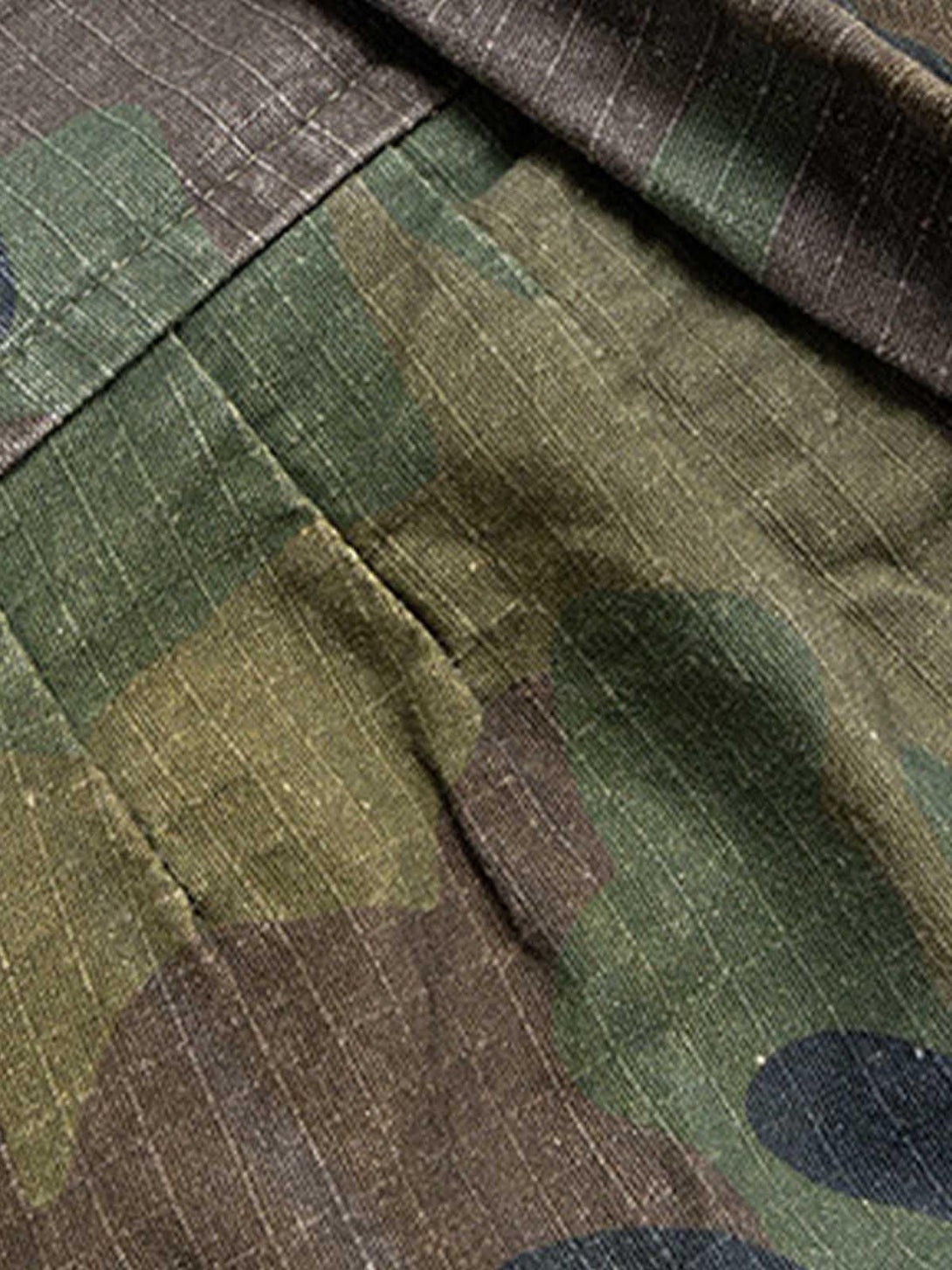 A tight crop highlighting TALISHKO's camouflage cargo shorts, emphasizing the fabric texture.