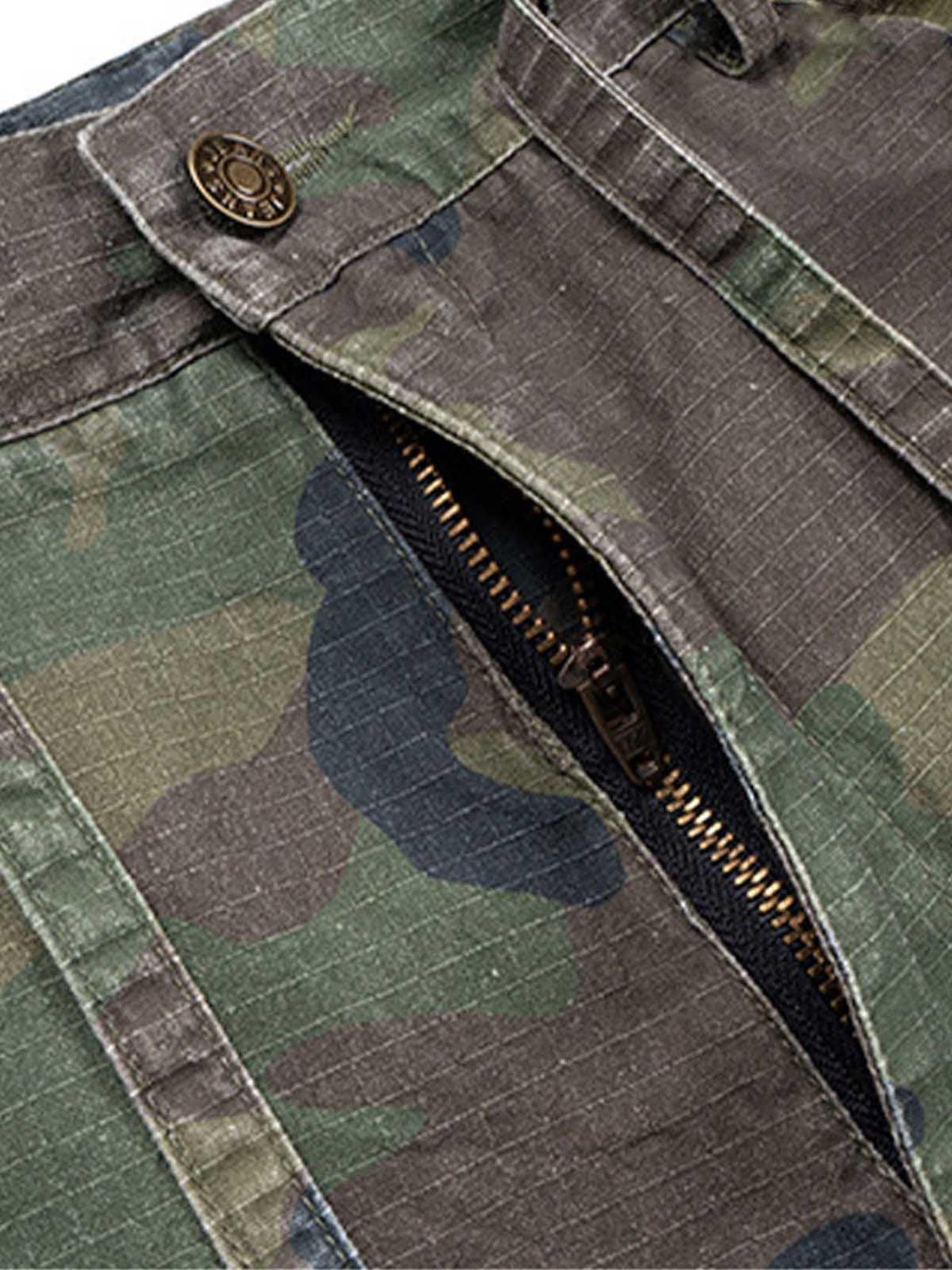 Detailed view of TALISHKO's camouflage cargo shorts, showcasing sturdy zipper and button details.