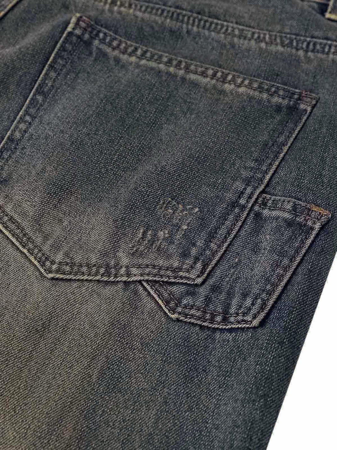 Focusing on the back pocket detail of TALISHKO washed dirty-dye straight jeans.