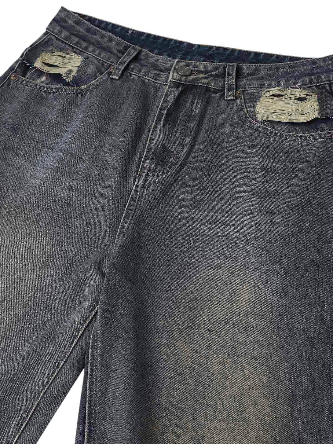 A detailed view of TALISHKO's distressed washed straight jeans, highlighting unique texture.