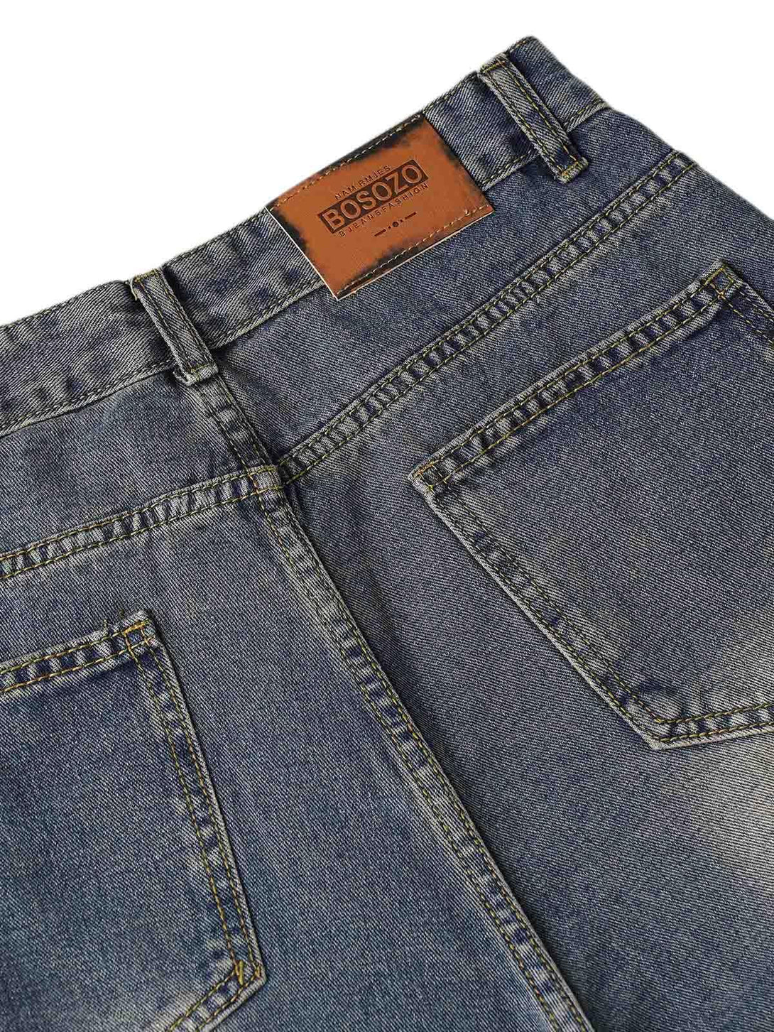 Back view of TALISHKO washed distressed baggy jeans, highlighting detailed pocket design.