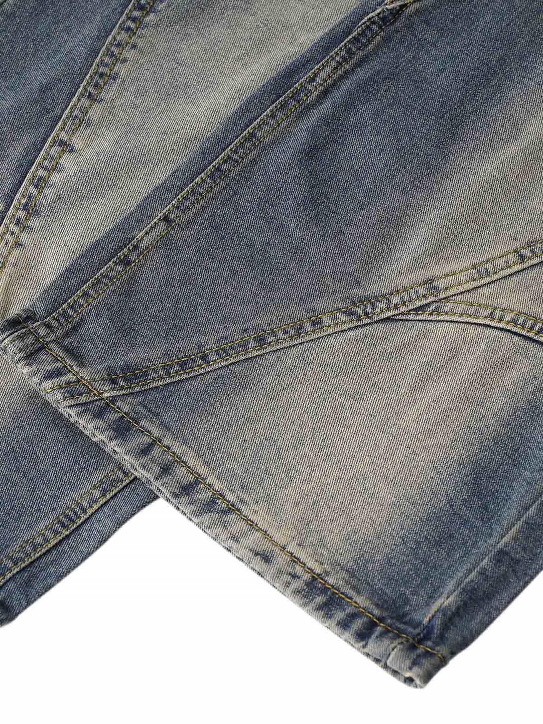 Detailed fabric and stitching of TALISHKO washed distressed baggy jeans, highlighting unique texture.