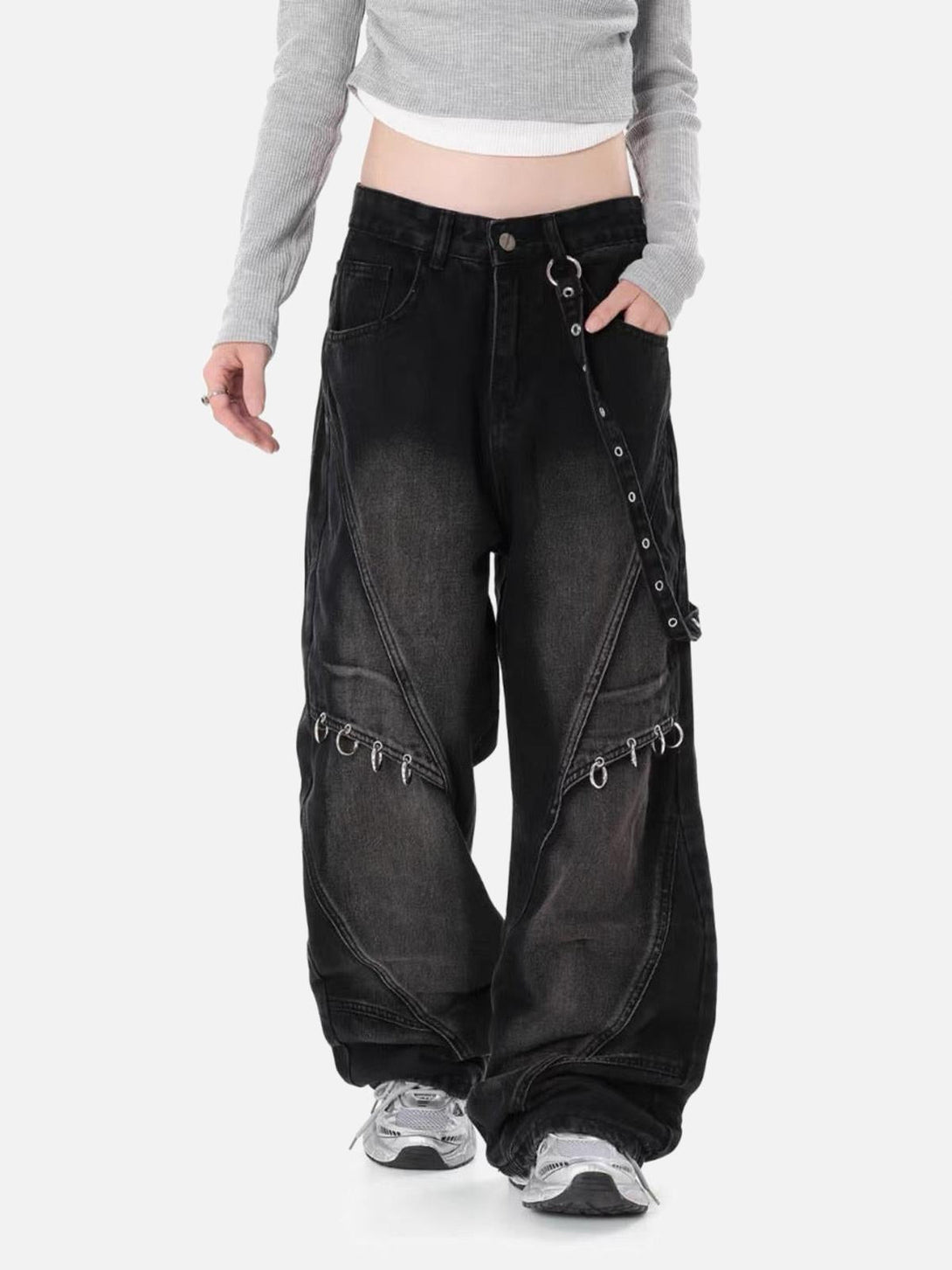 Model wearing TALISHKO washed distressed baggy jeans with edgy metal detailing for a bold look.