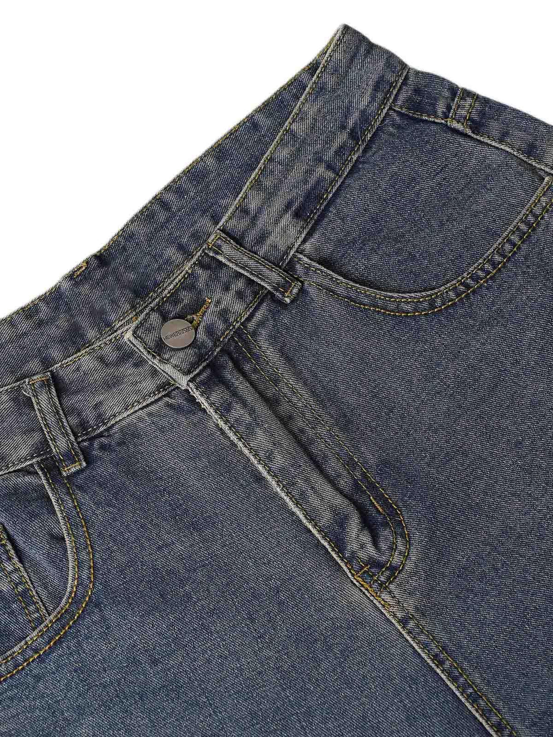 Detailed view of TALISHKO washed distressed baggy jeans, highlighting texture and stitching.