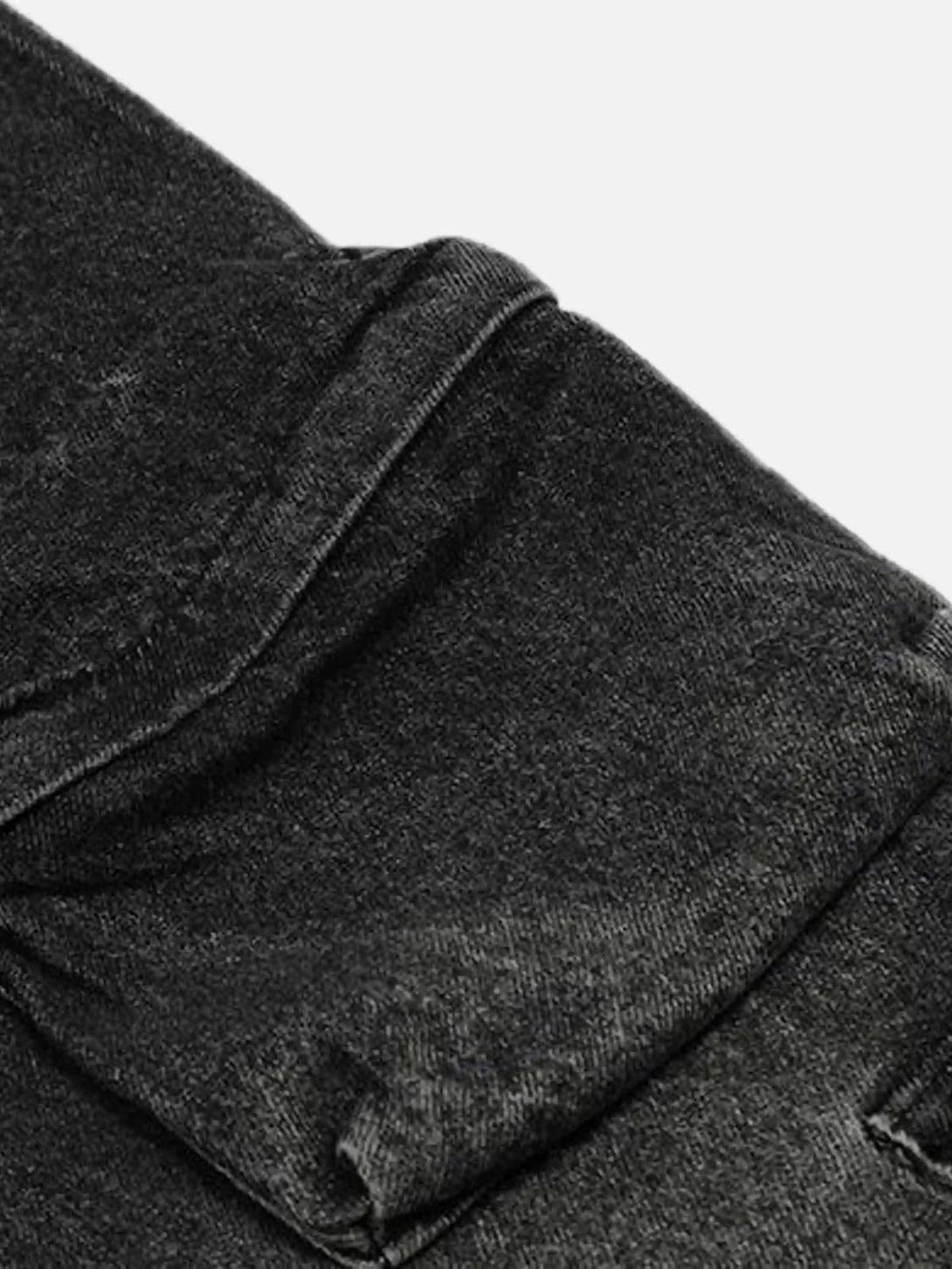 Focusing on the texture and cuffs of washed distressed jeans by TALISHKO, showcasing detail.