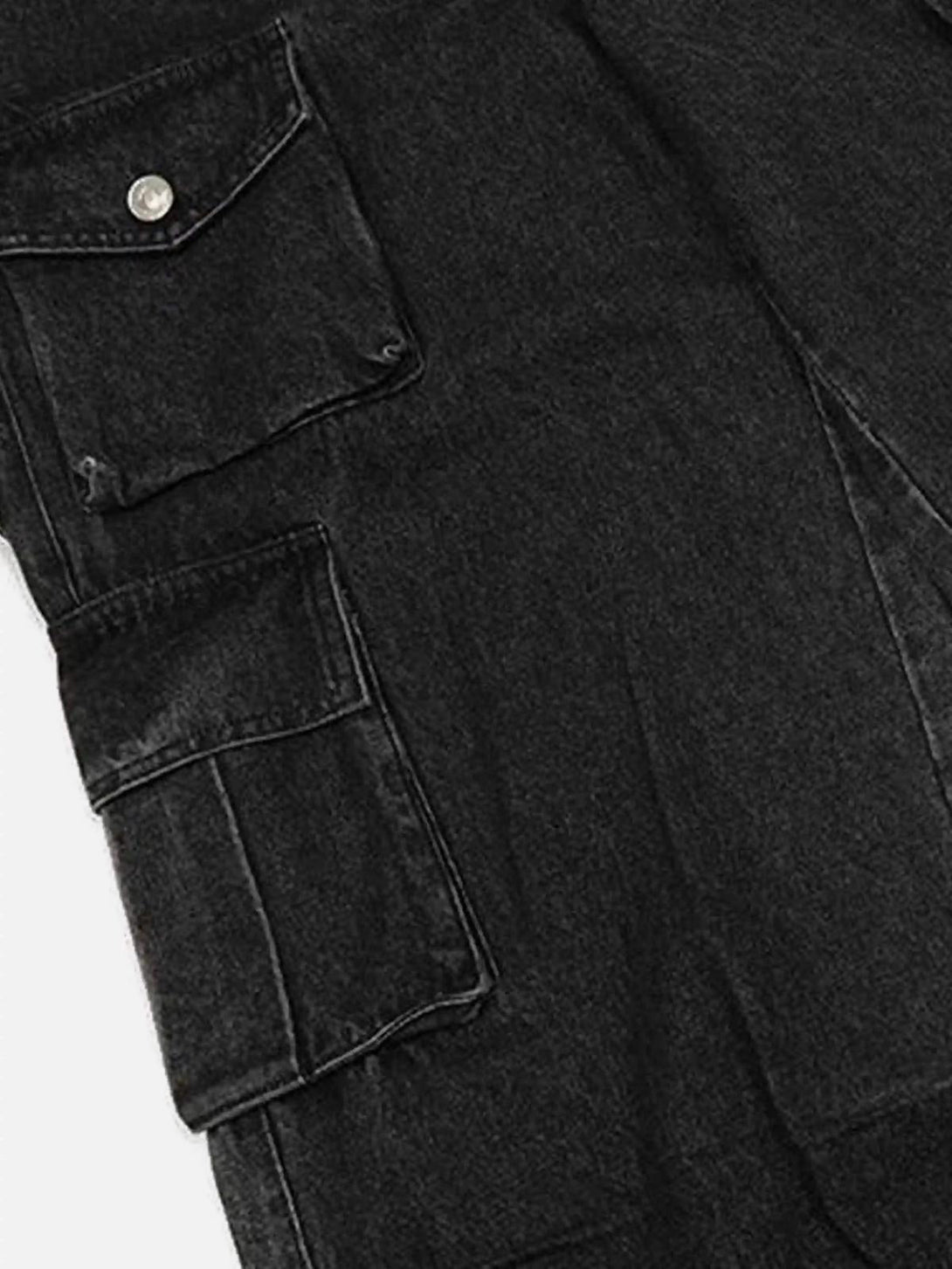 A tight crop highlighting the cargo pockets on black washed distressed jeans by TALISHKO.