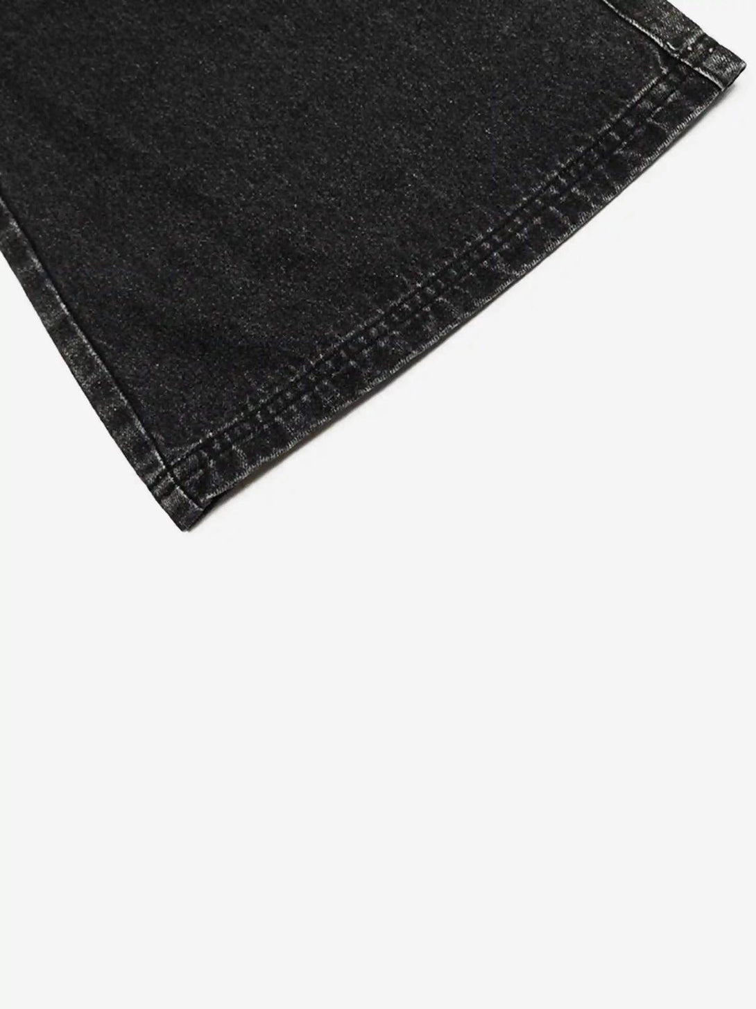 Zoomed-in texture of black washed distressed jeans by TALISHKO, highlighting the hem detail.