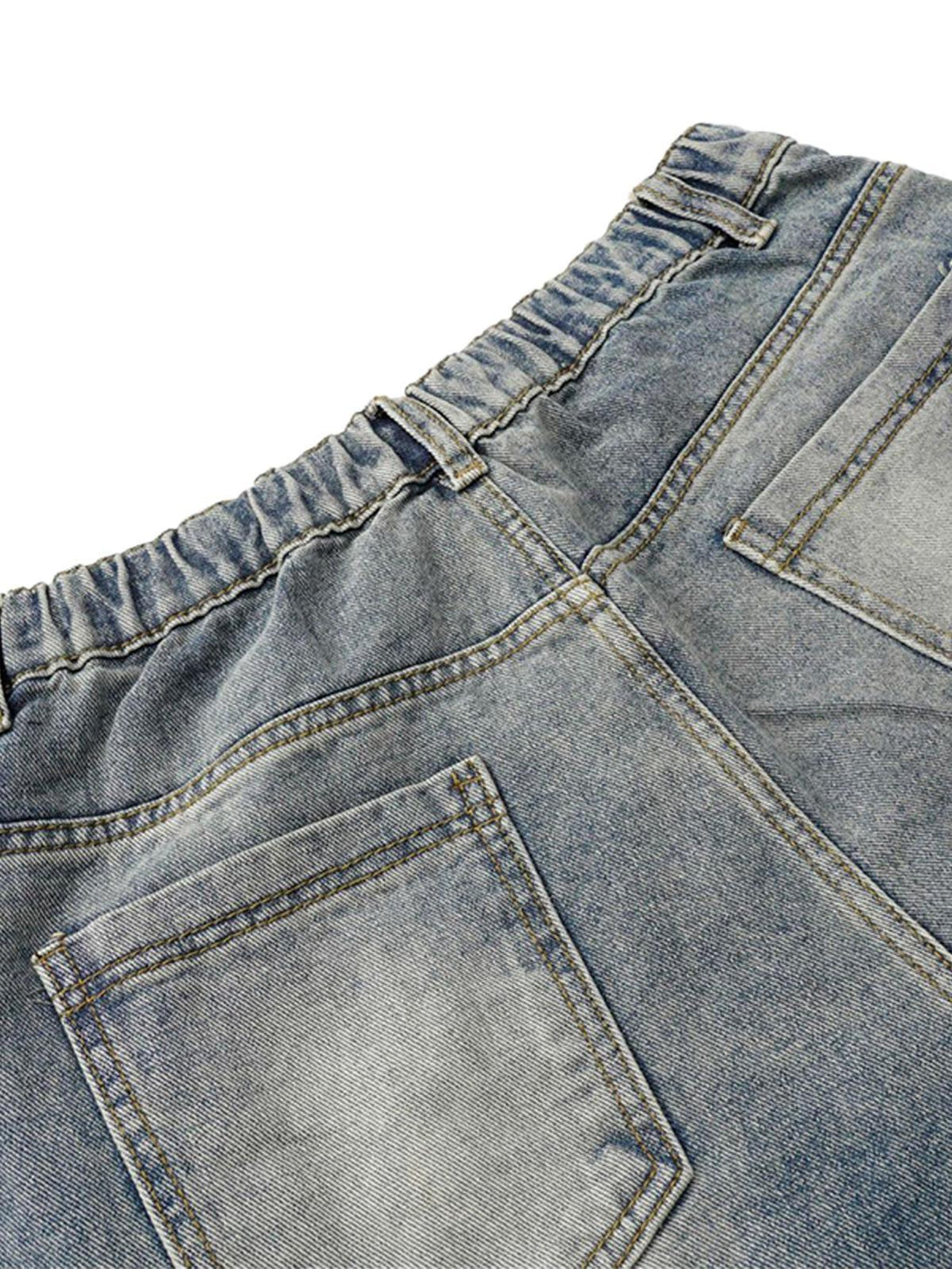A close-up of TALISHKO's washed distressed jeans, showcasing the elastic waistband and pockets.