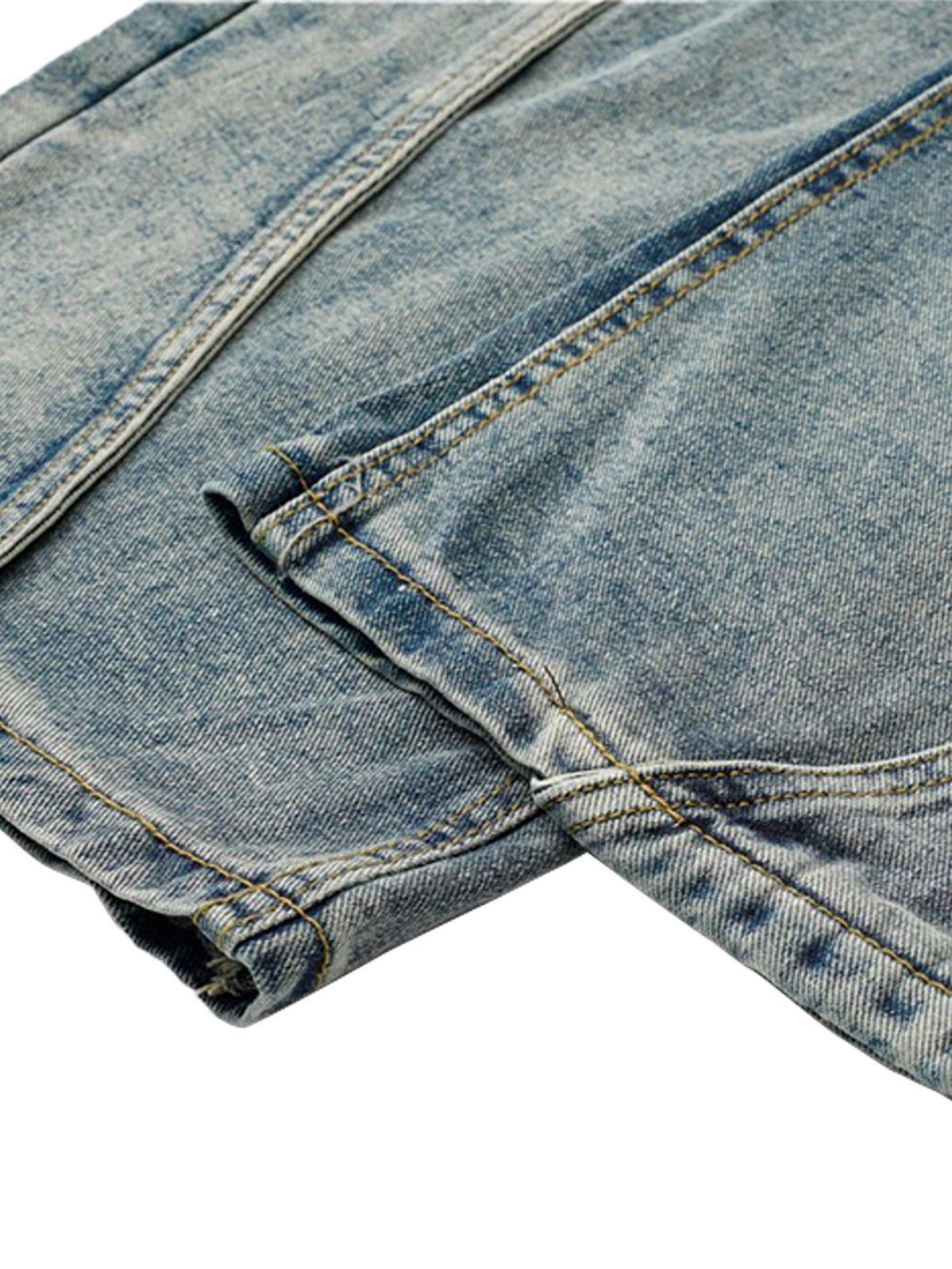 A detailed view of TALISHKO's deconstructed jeans, highlighting the washed and distressed texture.